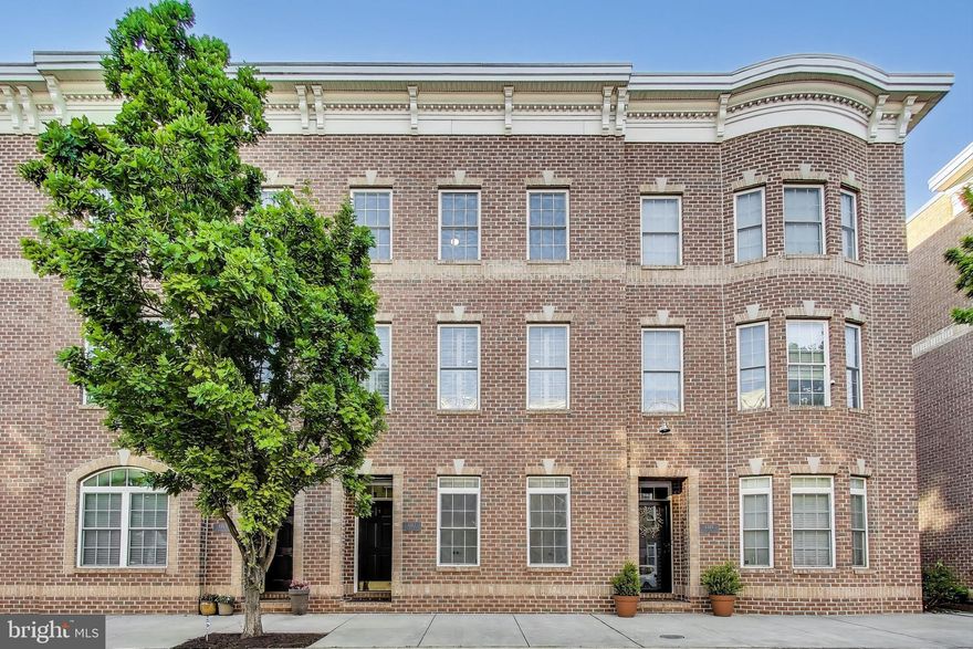 MULTIPLE OFFERS IN HAND AND BEING NEGOTIATED.  Welcome to your dream townhome in Locust Point, one of Baltimore’s most welcoming and walkable waterfront neighborhoods. This four-level, brick-front townhouse offers the perfect blend of modern style, comfort, and city living—with 3 bedrooms, 3.5 updated baths, and two spacious decks, including a rooftop retreat with sweeping views of the city. The first floor includes a private bedroom (wall-mounted tv conveys) and a full bath—perfect for guests, a home office, or creative space—plus a coat closet and access to a two-car garage with additional storage and a two-car driveway (as well as ample street parking right at the front door). The second floor layout is ideal for entertaining and everyday comfort, with open-concept living and dining areas, a bright kitchen [plentiful white 42-inch cabinets; a walk-in pantry; quartz countertops, including a breakfast bar; a center island; and stainless steel appliances (a four-door FlexZone fridge--one compartment can be used as a fridge or freezer, a gas range, a built-in microwave, and dishwasher)], "breakfast room" (it's actually a full-sized dining area, leaving the "dining room" available for other uses, such as an expanded living room), a laundry room (washer & dryer convey) and a composite deck with "walls" for privacy between adjacent neighbors (the furniture & gas grill convey) just off the kitchen for easy grilling or al fresco dining. The third level features a serene primary suite with a walk-in closet, a second double-door closet and a stylish en suite bath (quartz dual vanity, walk-in shower & privacy niche), plus a generously-sized second bedroom with a wall-mounted tv (conveys), a wall of closets and an attached full bath (also with hall access). At the top, unwind or host under the stars on your rooftop deck (this furniture also conveys) with unbeatable views (see included breathtaking Inner Harbor fireworks pictures). Whether you're sipping wine at sunset or enjoying fireworks (not only Inner Harbor, but also Fort McHenry on the opposite side) with friends, this is your sanctuary in the sky. Inside, thoughtful upgrades shine: upper-level heat pump (2024), hardwoods on the main level and stairs, new sleek matte black fixtures (contemporary lighting and  bathroom) and hardware (door handles, cabinet pulls, handrail brackets, etc.) throughout, new luxury vinyl plank flooring on the ground level and in the laundry room and bathrooms, plush new carpet upstairs (bedrooms and stairwell to fourth level), window treatments (plantation shutters and bottom-down/top-up blinds) throughout, elegant crown molding and overhead lighting in every room. All this just steps from numerous fields and parks (Federal Hill, Fort McHenry, Latrobe, Rash and Riverside), popular local dining/ice cream and snowball shops, boutique stores, a brewery (hosts events and live music), a grocer, the water taxi (to/from Locust Point, Federal Hill, Inner Harbor - Harborplace, Pier 5 - National Aquarium, Harbor East, Fell's Point--Maritime Park, Fell's Point--Broadway Pier, Lighthouse Point, Canton Park, and Fort McHenry) etc. On nice days, you'll see countless people out for strolls, walking dogs (or at the dog park), and pushing strollers as well  as neighborhoods and parks filled with kids (riding bikes, frolicking in bounce houses, enjoying a game of street hockey, playing little league) and adults (playing basketball, dodgeball, pickleball).  Do not miss this gem -- right where community, convenience, and culture meet in Charm City! [NOTE: Other furnishings on premises not specifically mentioned as conveying may be purchased.]  FYI: A developer has purchased Under Armour's former Cheer Building complex (at the end of Lowman) and is planning to redevelop it into luxury townhouses.