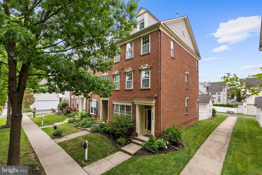 Rarely does a home in the Lakelands offer this combination of design, finish, and setting. Welcome to 1376 Main Mews, a meticulously upgraded Miller & Smith Georgetown end-unit townhome overlooking the Butterfly Commons and set peacefully away from main roads.
Step inside and the difference is immediate. Soaring 10-foot ceilings on the main level create a sense of volume and light that sets the Georgetown model apart from anything else in this price range. The open-concept living and dining area flows into a fully remodeled luxury kitchen (2025) featuring premium cabinetry, designer finishes, and high-end appliances, a true centerpiece of the home. Hardwood floors grace the main level and staircase, while the upper levels feature a high-grade, light-toned laminate selected for both beauty and durability. The main level doubles as an entertainment destination with a ceiling-mounted projector and remote-controlled 120-inch motorized drop-down screen, both conveying with the home, perfect for movie nights, game days, or an immersive cinematic evening experience unlike anything you’ll find in a traditional living room.
On the 2nd level, the primary suite offers a private retreat with two separate generous closets and a completely redesigned en-suite bathroom (2025) with modern fixtures and elevated finishes. A dedicated home office, thoughtfully converted from the original den, features modern built-in shelving and a clean, contemporary design, all conveying with the home. The 3rd level features the Georgetown model’s signature vaulted spaces with 10+ foot ceilings which add architectural interest. Additional 2 bedrooms are spacious and bright, sharing an updated Jack & Jill bathroom with two vanities, and offer large closet space. Flexible living space with signature vaulted ceilings can easily serve as a recreation room, media lounge, or home gym. Fresh paint throughout and thoughtful updates at every turn mean this home is truly move-in ready, no projects, no compromises.
Outside, a private stone patio is tucked between the home and the two-car garage, creating an enclosed outdoor living space ideal for grilling, morning coffee, or quiet evenings. As an end unit with brick on the front and side, the home offers enhanced privacy, natural light from multiple exposures, and timeless curb appeal. The Butterfly Commons, a native meadow sanctuary created in partnership with the City of Gaithersburg and the Chesapeake Bay Trust, sits directly in front, providing a serene, green backdrop with walking paths and gardens. It’s a rare amenity that offers permanent open-space protection and a connection to nature steps from your front door.
Location within the Lakelands is equally compelling: walking distance to Lakelands Park Middle School, community stadiums (soccer and two baseball fields), lakes, and the full suite of Kentlands/Lakelands amenities including pools, tennis courts, trails, and the vibrant town center with Whole Foods, dining, and shopping. This is not just a townhome — it’s one of the most thoughtfully finished Georgetown models in Lakelands, in one of its most desirable locations. Homes like this don’t wait.