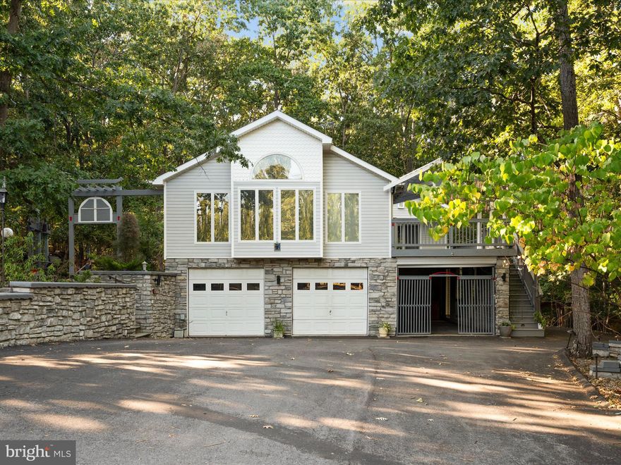 ***CONTRACT JUST FELL THROUGH at no fault to sellers, buyer’s home sale contingency fell through AND APPRAISAL WAS AT LEAST 425k!***  PRICED 50k UNDER ASSESSED VALUE and with minor updating this would make for A GEM! Come live the lake life in this contemporary raised rancher! Just a short walk to the beach, this beautiful stone-and-vinyl siding home on a quiet cul-de-sac offers the perfect balance of privacy and convenience. With 4 bedrooms, 3 baths, and over 3,000 sq ft, there’s room for everyone to relax and enjoy. Step inside to a soaring great room with vaulted ceilings and walls of windows, a freshly painted main level, and an updated kitchen with expansive cabinetry and modern appliances. The spacious sunroom connects two main-level bedrooms, creating the perfect flex space for an office, playroom, or lounge. Downstairs, you’ll find two additional bedrooms, a den, and space ready for a possible  kitchenette—ideal for guests or multi-generational living. Outside, enjoy upper-level decking, a 2-car garage plus an additional covered carport and still additional paved parking. Best of all, you’re just steps from Beach 1, the clubhouse,  dog parks, sports courts, playground, and marina for boating adventures. This home truly has it all—lake amenities, wooded privacy, and space to grow.