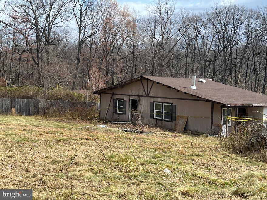 Situated in the Shenandoah Farms community  of Front Royal, just roughly 1 mile to Shenandoah River. 704 Western Lane offers an opportunity for investors, builders, or buyers seeking a property with redevelopment potential. The parcel includes an existing structure; however, the structure is not considered safe and should not be entered by buyers or agents.

The property currently utilizes a well and septic system that are shared with an adjacent property and are reportedly in use. Documentation related to these systems—including permits, surveys, agreements, or health department records—is not available. The seller has stated there are no known liens on the property. Buyers should perform their own due diligence to determine the location, functionality, legality, and adequacy of the well and septic systems for any future use.

This property is located within a Sanitary District and is being sold strictly AS-IS with no warranties or guarantees, either expressed or implied. Purchasers are responsible for verifying all property details, including utilities, zoning, lot boundaries, access, structure condition, permitting requirements, and feasibility for renovation or new construction.

Residents of Shenandoah Farms enjoy access to community features such as lakes, trails, playgrounds, and outdoor recreation areas, along with nearby public access to the Shenandoah River. Local parks and community resources further enhance the appeal of the surrounding area.

Whether the plan is to renovate, rebuild, or develop, 704 Western Lane presents a chance to bring new vision to a property located within an established and amenity-rich community.