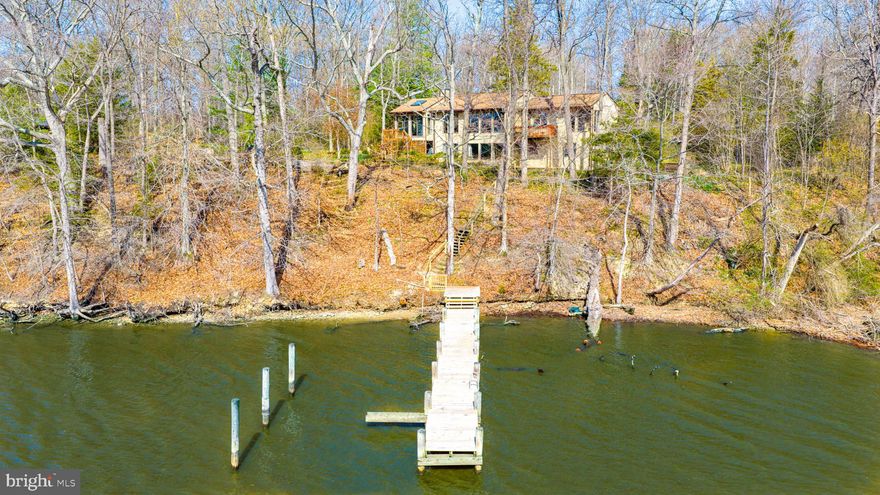 Toad Hall, as the current owners affectionately call it, is located in a natural wooded setting on Fairlee Creek in Great Oak Estates just minutes from the Chesapeake Bay. Peaceful water views from almost every room in the home create the feeling of living in a tree house, and the dock is just steps away down the hillside - no flood insurance needed.  Enter the house through a split foyer with a few steps up to the main level and into the great room with the central kitchen, dining and living areas.  The master suite is located on one end of the main level and features a large walk-in tile shower and a small private deck.  The other end of the main level features a vaulted sunroom, a great spot to commune with nature or host the family crab feast.  The lower walk out level offers a family room with a wood stove, two bedrooms, a full bath, a laundry room, and outdoor access.  2.5-3' MLW Buyer to verify.   See Documents for Seller updates plus info on Association benefits.   New roof added in 2021 and a BAT septic system was installed in 2023.   Property has been well maintained but is being sold AS IS.