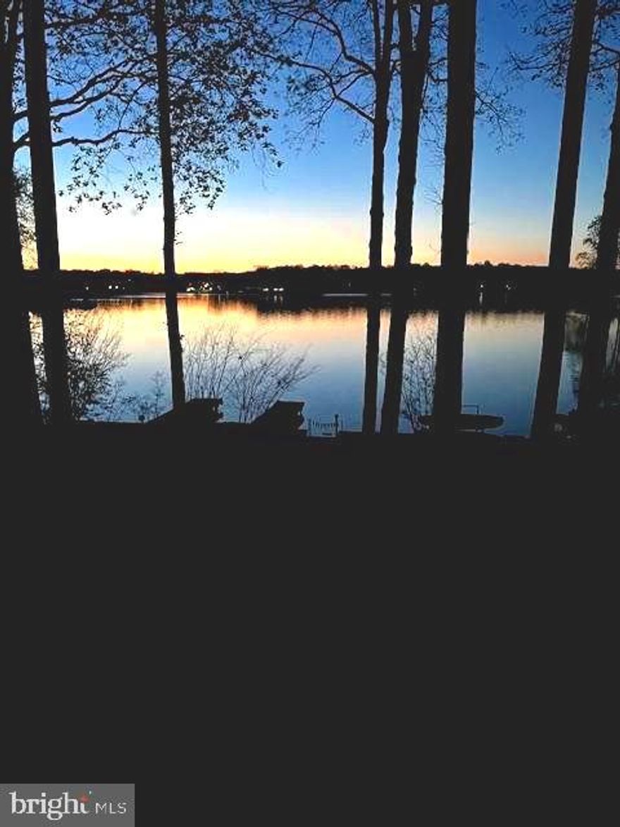 Imagine waking up every morning to the gentle whispers of the lake and the golden glow of breathtaking sunrises that fill your heart with peace. This isn’t just a house; it’s a sanctuary where every corner tells a story of love, care, and thoughtful upgrades that enhance the stunning lake views you’ll cherish forever.

Nestled on a generous 25,000sf lot, picture yourself unwinding on the new, spacious screened porch and deck with Timbertech Aztec flooring & elegant wire railings. Step through the new triple French doors and feel the seamless flow to this screened porch and deck or take the side back stairs to the new door.  This all crafted for your ease and enjoyment. You’ll feel the soft breeze and a wide-open view across the beautiful lake.    Under deck water drainage system, cedar ceiling & deck posts  add to the beauty of this outdoor space.  The warmth of the sun is felt with a serene beach just a few steps away inviting you to relax and reconnect with nature. An outdoor shower offers a refreshing escape after a day on the lake!  
The addition of the charming concrete, slate & stone front porch with radiant floors greets you with warmth as you enter the custom front door.  You will experience a grand entrance that frames the stunning lake views like a masterpiece. Foyer was redesigned to a larger entrance space just made for a reading nook.  Shiny new hardwood floors in family room with gas fireplace leads you to an open-floor plan, the large island with granite counter & kitchen with new gas stove. Lage sliding glass doors & a large picture window were added to enhance the view from inside & exit to the screened porch. 

Outside this lovingly renovated home also boasts a brand-new Timbertech Aztec dock, perfectly designed with new footers, ramp, and bulkhead, plus a U-shaped dock ready to welcome your boats and endless adventures on the water. Garage was transformed to a front entrance, adding new concrete floor, exterior drainage pad, mid-century modern garage doors, Pella windows & man door to front patio as well as new garage door openers.  Exterior brick painted to enhance the beauty of the new design & windows.

Efficiency meets beauty — from the wrap-around deck added (where there was only a stoop) to the modern ceiling fans and lighting, the inviting TV hookups, all-new Pella windows, updated soffits, gutters, and pest-proof attic vents. The lower-level recreation/game room opens to a concrete patio through two added sliding doors, inviting laughter and memories. Additional thoughtful improvements include a new culvert pipe & asphalt driveway with enhanced drainage.  A welcoming sidewalk leads to the lower patio — all designed to make life easier and more beautiful.

With 3,990sf of lovingly maintained indoor space and extensive outdoor renovations, this home is more than a place to live-- it’s where your heart will find its home. Every detail inside and out reflects a commitment to comfort and style.  Don’t miss the chance to embrace the ultimate waterfront lifestyle and create memories that will last a lifetime.