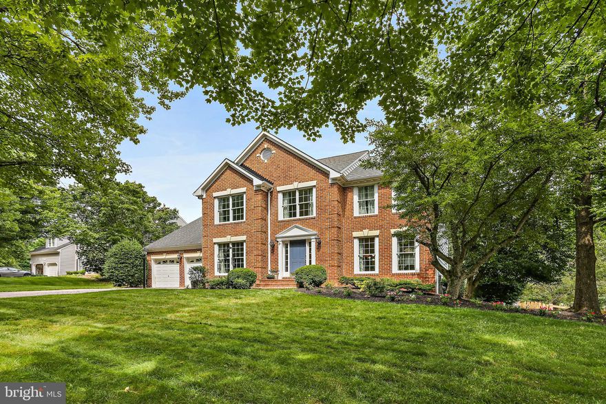 Offers due by Tuesday , 07/01, at 5 pm. Gorgeous brick-front Colonial nestled on a beautifully landscaped half-acre lot in the highly sought-after River Hill community! This meticulously maintained home features a spacious, fully fenced backyard, and lush lawn with flowering beds and spectacular flowering trees. Inside, enjoy hardwood floors throughout most of the main level, a private home office with custom bookshelves and French doors, and a formal dining room with bay windows. The gourmet kitchen includes a center island, ample cabinetry on three side walls, granite countertops, glossy backsplash, and a bright breakfast area with extended box bay windows, opening to a family room with vaulted ceiling, a floor to ceiling stone fireplace, Brazilian hardwood flooring, and sliding doors to an oversized deck— perfect for relaxing or entertaining.
Upstairs offers 4 bedrooms and 2 beautifully updated bathrooms, including a stunning primary suite, cathedral ceilings in the bedroom, a sitting room, two closets including a walk-in, and luxury bathroom with a skylight, spa shower with frameless glass enclosures/doors, and soaking tub. The hall bath is also tastefully updated, boasting designer tiles and a double sink vanity. Wood flooring is installed in all bedrooms, throughout the hallway and stairs. The  awesome walkout basement offers a full wet bar, wine cooler, home theater, 5th bedroom, 3rd full bath, and luxury LVP flooring—plus direct access to the huge backyard, ideal for sports and gatherings.
HVAC, water heater, and roof replaced in recent years. Easy parking with a long driveway and large front circle. Prime location—walk to the Mid-Patuxent Environmental Area with river and sand beach, and minutes from River Hill schools, shops, restaurants, CA amenities, trails, and commuter routes (108/32/29/95). MOVE IN READY.