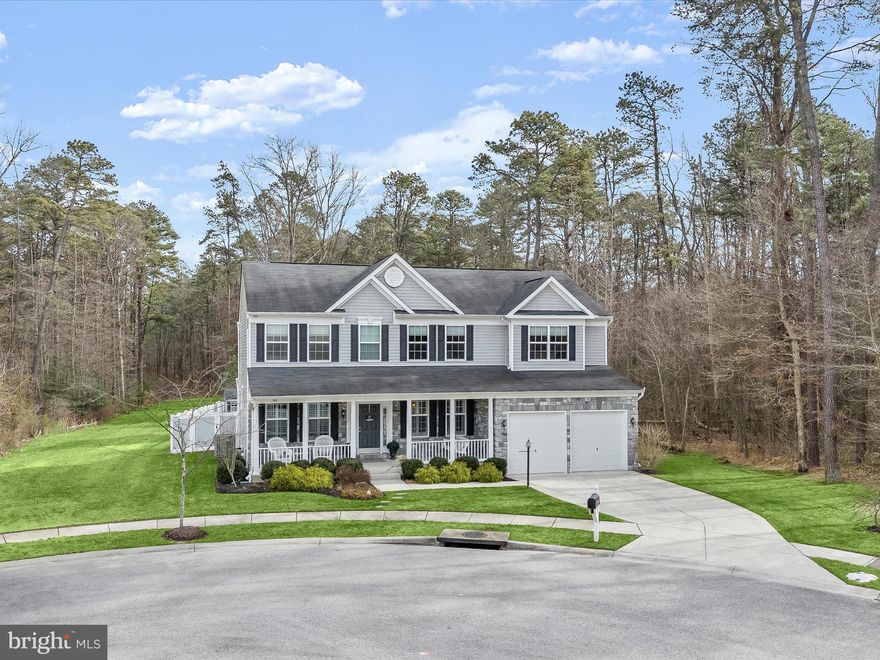 Welcome home to this beautiful and meticulously maintained K.Hovnanian-built 5 bedroom 3.5 bath colonial with 2 car garage at the end of a cul-de-sac in sought-after Brookwood Run * Save thousands - $750/year Front Foot Fee PAID IN FULL through 2047 by Seller * Premium builder lot perfectly situated on 0.23 acres backing to wooded open space * Sit on the large covered front porch and chat with neighbors and guests * Enter through the formal foyer with hardwood flooring that extends down the hallway and throughout the gourmet kitchen and breakfast room * A formal living room and dining room with neutral carpet, crown molding, and plantation shutters straddle the foyer and provide space for special occasions * Beyond the formal space is a main level powder room and home office/library * Many windows provide tons of natural light in the two story great room/family room with neutral carpet and a dramatic stone mantle with gas fireplace * Semi-connected to the great room is the gourmet kitchen featuring dual ovens, gas cooktop, built-in microwave, granite counters, large pantry, chef’s desk, and a center island/breakfast bar with seating to prep food or just gather* The connected breakfast room also features a breakfast bar for 4 and table space with seating for up to 10 people * In the back of the house is the special all season sun room with separate HVAC and expansive views of the backyard and wooded open space * The upper level features generously-sized bedrooms including the primary suite with huge walk-in closet and luxury bath with dual vanities, a premium ceramic tile floor and shower surround, separate soaking tub, and water closet * The hall bathroom also has dual vanities * The washer/dryer is located on the bedroom level too * The finished basement features premium carpet/padding throughout and has wide walk-up stairs to the backyard * The family room/game room is big enough for movie nights, game table, and even a pool table/ping pong table * A fifth bedroom, perfect for in-laws, guests, or teenagers, is tucked in the back of the basement and has a large walk-in closet and full bathroom * The huge basement storage room finishes off this versatile level * The backyard is an oasis with a large curved paver stone patio, level yard, and separate paved fire pit in the back of the yard * A useful shed is included * The backyard is only partially fenced but can be fully fenced if the new owner wishes * The property features a handy whole yard irrigation system and other builder extras including a holiday lighting/electrical package, sump pump battery backup with water-powered backup system, and a whole house humidifier * The property and community offer excellent access to major commuter routes to Fort Meade, Baltimore, and DC * Experience the pleasure of Brookwood Run living in this magnificent property!