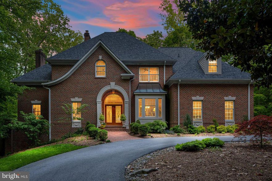 Beautiful, custom, Belvoir Farms, brick colonial. A wonderfully convenient location with easy access to Annapolis and Route 50 with a serene, private setting. You know you are arriving someplace special when you arrive on the circular drive, flanked by brick columns. Park beside the brick sidewalk leading to the covered, arched, entry. You will enter the 2 story foyer with marble floors and elegant, open staircase. On your right is a classic dining room with crown molding. To your left is a study featuring tray ceiling with custom lighting and half bath. Entering the home into a beautiful living room with double french doors overlooking the private slate patio and custom shaped pool. The living room features a gas fireplace surrounded by custom built-ins and hardwood floors. As you walk toward the kitchen, through the hall you will notice a wet bar, conveniently located for entertaining in the living and dining rooms. The gourmet kitchen has a large island with plenty of seating for informal dining and is located adjacent to the laundry/mud room with a full bath and entry to the attached 2 car garage. The kitchen with granite counters and ample cabinet space is open to the family room with 2 story, wood plank ceilings, wood burning stone fireplace, wood floors, sliding glass doors to the screened porch with tile floor and wood plank ceiling and a glass door with access to the patio and pool deck. On the main floor, off the living room is the master bedroom. Elegantly appointed with a propane fireplace, his and hers closets and gorgeous, remodeled master bath. The master bath features his and hers vanities, soaking tub by palladium windows with a view of the private treed back yard, heated tile floor, custom glass door shower, tray ceiling with ambient lighting and commode room. On the upper level there are 4 generously sized bedrooms and 3 full baths. One of the bedrooms has a private, cozy sitting area with wood plank ceiling, overlooking the family room. The tour is not over, there is more. The lower level features a large family/game room with another propane fireplace. Off the family room is the 6th bedroom with full bath and a walk out to the side yard patio. There is a craft room and exercise room and tons of storage and additional unfinished space to make a shop, playroom, theater, whatever your heart desires. Before you depart, notice the detached 3 car garage and the fenced, private back yard adjacent to open space. Belvoir Farms community has tennis courts, a tot lot, marina and is conveniently located across Generals Highway from the newly renovated Eisenhower Golf Course. Live life with elegant style and grace at 1604 John Worthington Way.