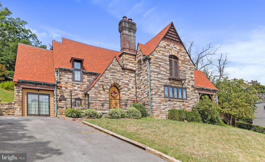 This exquisite, Tudor-style home stands as a testament to timeless beauty and craftsmanship. The exterior showcases a stunning symphony of textures, with carefully arranged irregularly shaped stones that create a sense of rugged elegance. The steeply pitched roof, featuring a decorative chimney stack, adds to the architectural allure.  The arched stone doorway welcomes you into a world of sophistication. Inside the main level of the home, you'll be enveloped by the warm embrace of hardwood floors, 8'5" ceilings, and beautiful trim work around every doorway. The formal dining room, living room, and breakfast room all seamlessly flow from one to the other, as they radiate both sophistication and historical charm. The kitchen blends modern amenities with the antique aesthetic, highlighting granite countertops, a double sink, and glass pane cabinetry. Just off of the kitchen, a half bathroom and pantry are located close by for your convenience. Ascending the charming staircase leads you to the second floor filled with four bedrooms, which feature a continuation of the beautiful hardwood floors! Two of the four bedrooms boast their own private, full bathrooms. The other two bedrooms share a large Jack & Jill bathroom.  Other features of the property include a workshop, and an unfinished basement with laundry and tons of storage space featuring custom-built shelving. Outside, the beautifully-crafted stone features continue on with a large courtyard and covered porch area - creating a serene escape that perfectly complements the architectural magnificence of the rest of the home. All of this is located just a short drive to both historic downtown Cumberland AND the many amenities of LaVale. Also close by is Northrop Grumman, IBM, UPMC Hospital, Allegany College of Maryland and much more! Doesn't this sound like a dream? Well, come see it for yourself to make it your reality!
