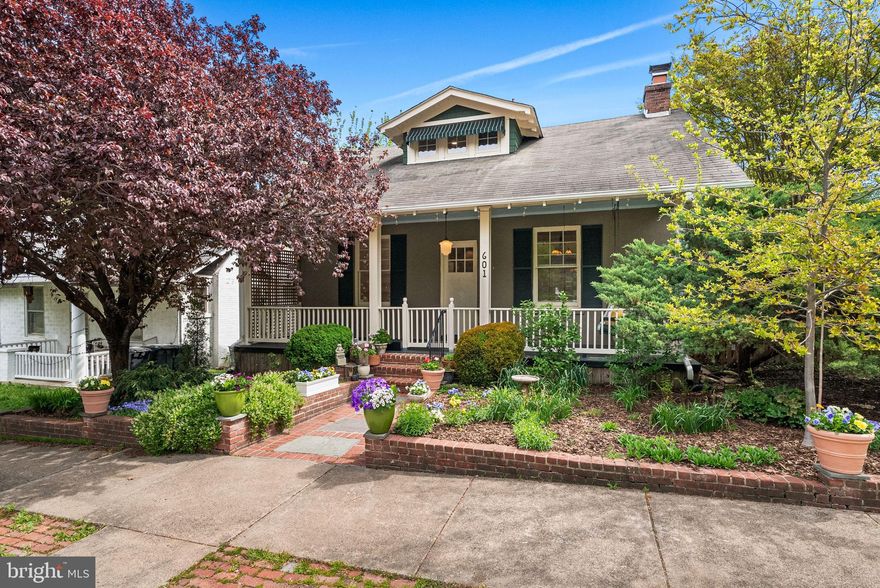 • Welcome home to 601 N View Terrace in exclusive Rosemont — a stunning 6-bedroom, 3.5-bath Craftsman bungalow on a spacious corner lot with beautiful curb appeal and professional landscaping.
• FRONT PORCH: Large, inviting, and picture-perfect with a hanging swing — ideal for morning coffee or relaxing outdoors.
• ENTRYWAY & LIVING SPACE: Freshly painted interior with gleaming hardwood floors. Living room features a wood-burning fireplace with a classic mantle and a striking light fixture that reflects the home’s timeless charm.
• LIBRARY: To the right of the entry, a full wall of built-ins and chandelier lighting creates a warm, functional space for reading or working from home.
• FORMAL DINING ROOM: Spacious with a bay window, window seat, original/vintage lighting, and abundant natural light — perfect for entertaining.
• KITCHEN: Recently updated with stained glass windows, stainless steel appliances, including a brand-new dishwasher, a Viking 5-burner gas range with matching vent hood, and new quartz countertops. The breakfast room is filled with natural light and overlooks the backyard oasis.
• PRIMARY SUITE: Located on the main level, featuring a spacious bedroom with abundant light, an attached sitting/dressing area, and a newly renovated en suite bath with tiled shower with dual heads, a vintage vanity, and new fixtures and lighting.
• POWDER ROOM: Unique touches include original New Yorker covers adorning the walls.
• UPPER LEVEL: Three well-appointed bedrooms with walk-in closets, freshly painted walls, and hardwood flooring. The updated hall bath, with wainscotting, a tub/shower combo, and a vanity, completes this level.
• LOWER LEVEL: Feels like an additional home — includes two bedrooms with ample natural light and closets, a rec room with walk-out access to the patio, and a full updated bathroom with a shower. A large linen closet is also on this level.
• BACKYARD OASIS: Professionally landscaped with multiple living spaces — walk-out patio from lower level, Trex deck off breakfast room, and paver sitting area near detached studio. Perfect for entertaining, relaxing, or outdoor activities.
• DETACHED STUDIO: Accessible from side street or backyard — ideal for an office, home gym, workshop, or creative space.
• This home offers an incredible blend of character, modern updates, and flexible living spaces — WELCOME HOME! Love where you live!