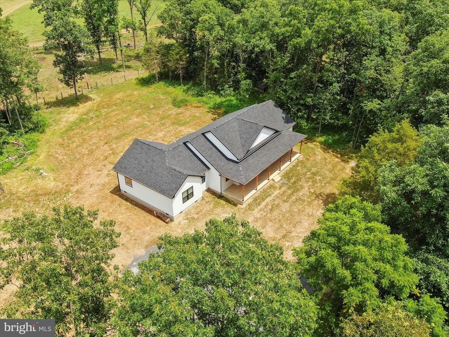 Escape to this 4-bedroom, 2.5-bath home on 1 unrestricted acre in Jefferson County! Surrounded by woods and farmland, this property blends privacy with stunning views. Inside, enjoy an open living area with cathedral ceilings, a panoramic window, and a sleek electric fireplace. The gourmet kitchen boasts black stainless appliances, granite counters, a sunny walk-in pantry, and a huge island perfect for gatherings. A dedicated office, spacious laundry with sink, and tray-ceiling accents add both function and style. Outdoors, relax on the oversized covered porch or take advantage of the brand-new 2-car detached garage (in process of being installed), Peace, space, and modern comfort all in one!In addition to the luxury feel, character and practicality this home offers, there's also a dedicated office with built-ins. Laundry is made easier with a large laundry room complete with cabinetry and a soaking sink for added convenience.   Whether you're taking in the peaceful sounds of nature, watching the local farm animals (or your own!)  or simply enjoying the freedom of unrestricted land, this home is a perfect escape from the everyday!!  Schedule your private tour today!!!