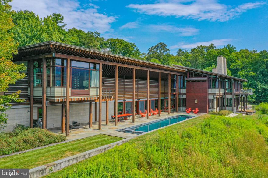 Seeking sanctuary?  During times of uncertainty, nothing provides greater peace of mind and a sense of comfort than the knowledge that you and those you love are safe and protected at home.  This exclusive 13,800 s.f. family compound was built to provide easefulness during such times.  The home sits in the middle of a 100-acre parcel of breathtaking, secluded land adjacent to the base of the Hawk Mountain Sanctuary and its 13,000 acres of protected woodland in Eastern Pennsylvania.  Yet its location is just 2 hours by car along I-78 from New York, and closer still to Philadelphia.  Enjoy the very best of rural country living with great local services, just a short drive from the city.World-renowned architect Peter Bohlin, FAIA, was commissioned to design a solid, timeless home made of stone and wood, resistant to style trends, upon this bucolic hillside- a home that would allow its inhabitants to live and work remotely isolated from the outside world while enjoying stunning views and active engagement with nature all around.  Mr. Bohlin is recognized for conceiving many high-profile designs over the years, including some of the most-publicized Apple stores around the world, and he has the distinction of creating the private residences for both Bill Gates and Steve Jobs.  The award-winning Blue Mountain Estate has been featured in Architectural Digest magazine and books and journals throughout the world.  It is a substantial, well-conceived, and elegant property completely unlike any other in the Mid-Atlantic region and offers more thoughtful details and amenities than can be properly detailed in this space- including 6 fireplaces, an underground security bunker, guesthouse, 6-car garage, elevator, and a backup electric generation system.  Local zoning regulations permit a helipad, if so desired.   Mr. Bohlin said recently the following of the home:    -"One approaches the house on a road that begins in the valley and winds up the field into the forest and then discovers the entry courtyard.  The house is built of stone and timber and sits firmly upon its site.  It is a great house with very appealing guest facilities.  It is one of our best houses, and one of my personal favorites with an extraordinary site that looks across the valley to Hawk Mountain.  To watch raptors, hawks, and eagles flying along the ridge is a terrific experience"-.