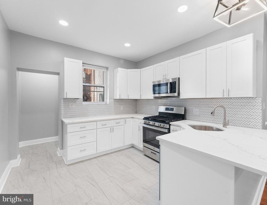 Your Dream Home Awaits in Cobbs Creek! This fully renovated 3-bedroom, 1.5-bath gem offers everything you've been searching for. Enjoy seamless living with an open floor plan and the beauty of brand new gleaming wood flooring. The heart of the home, the kitchen, is a showstopper with its fresh white shaker cabinets, stylish white quartz countertops, and modern stainless steel appliances – perfect for cooking and entertaining. Refresh and rejuvenate in the brand new modern bathrooms. Plus, enjoy the privacy of your own small rear yard. Don't miss the chance to own this move-in ready home in the desirable Cobbs Creek area of Philadelphia. Schedule your private tour now!