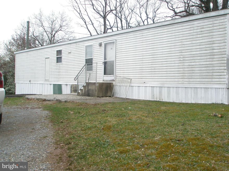 Enjoy the beautiful evening view from your .97 acres of property.  Mobile home can  use some tlc, , but All NEW PIPING THROUGHOUT, NEW UNDERCARRIAGE WATER VAPOR BARRIER, AND UV LIGHT INSTALLED AT WELL.   3-bedrooms, spacious bathroom, NEW laundry hookups, and wide hallways.  Cinder block shed/workshop is setup for electric, water and has a chimney.  Being sold 'AS IS".