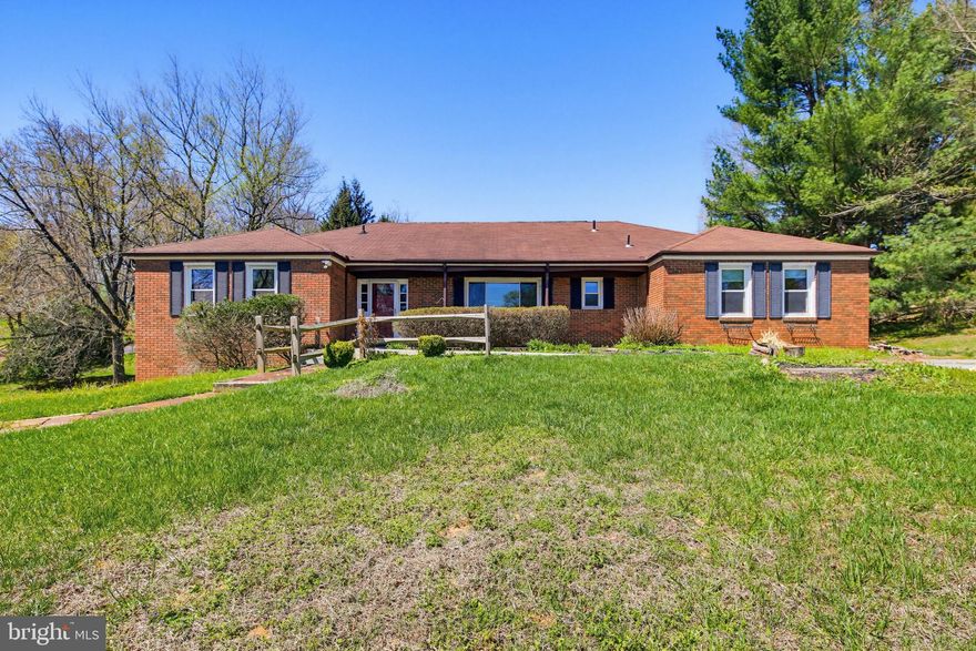 Tons of potential! Lovely brick rancher on a pastoral acre! Spacious rooms, including a huge family room with a brick fireplace. Sliding glass doors to a deck overlooking your country view. Big kitchen with room for an island, and excellent eat-in area/dining space. Four spacious bedrooms including a primary with en suite. Two driveways--one paved to the side and front, and one gravel driveway leading to the basement side entry garage.  The basement is unfinished but has a few rooms for storage and a workshop. This is being sold by a fiduciary and is AS-is. But it's a fabulous opportunity to get a great house that needs some cosmetic work. Well and septic reports available. Solar panels are leased.