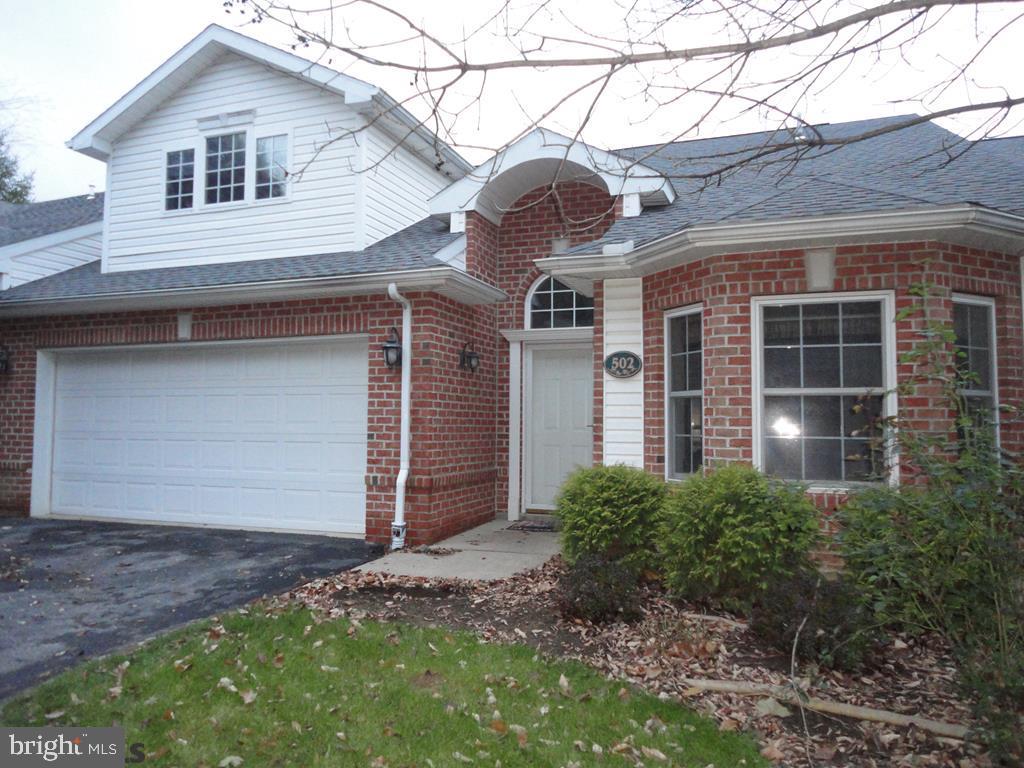 Enjoy living in this beautifully maintained maintenance free 3 bed, 3 bath condo located just minutes from the center of town! The first floor features 10 foot ceilings in the foyer and living room which boasts a double sided fireplace that also serves the beautiful sunroom that is filled with natural light. A large, private master suite with walk in closet and master bath is located just off the living room. Another bedroom can be found on the first floor along with first floor laundry just off the kitchen. The kitchen with its newer Corian counter tops and tile backsplash is open to the living room and dining room. Upstairs your guests will enjoy their own guest suite with full bath. The 2 car garage has storage shelving with more storage found on the second floor and above the walk in closet in the master suite. These units don't come on the market often so mark the date and come and see!