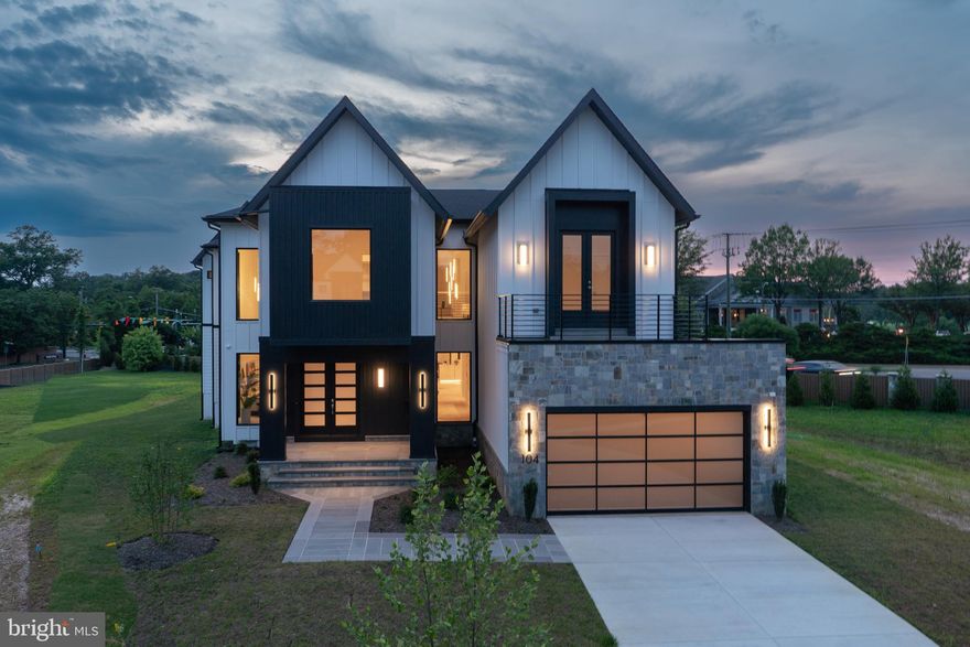 Experience elevated living in this luxury new construction architectural gem—where thoughtful design, luxury finishes, and a prime location just steps from Westwood Country Club come together seamlessly. Designed with entertaining in mind, this home offers the perfect setting for hosting everything from large celebrations to intimate gatherings with ease and elegance.
A dramatic two-story foyer welcomes you into over 7,450 square feet of artfully crafted living space featuring 7 bedrooms and 6.5 bathrooms. The open floor plan flows effortlessly through formal and informal living areas, highlighted by 10-foot ceilings, expansive picture windows, and warm wide-plank hardwood floors throughout the main level. The chef’s kitchen is a true showstopper—complete with a 9-foot center island. For easy everyday living there is a supplemental culinary food prep with a large sink, serving counter, built-in cabinetry and a second dishwasher. Miele appliances, a 60-inch side by side refrigerator, a built-in plumbed coffee station, and a separate butler’s pantry, all beautifully designed for everyday living and effortless entertaining.
The family room features a sleek ceiling design with integrated tape lighting, a linear gas fireplace with passive heat flow, and a wall of windows that open to a massive deck with a trellis-style ceiling and shades—creating a seamless indoor-outdoor experience for guests. There is also a screened porch which is accessible from the kitchen, family room and the deck.  Round out the main level is a secondary suite that can be used as an office or bedroom, adding to the versatility of the home's layout. Completing the main level is a spacious three-car tandem garage equipped with two EV charging outlets.
The open staircase, detailed with custom Poplar wood partitions, is a design centerpiece leading to the second level where you are greeted by a spacious informal living area. The primary suite is a luxurious retreat featuring its own heating and cooling system, two walk-in closets, a spa-inspired bath, and a private sitting room with fireplace—ideal for ideal mornings or unwinding at the end of the day.  Three additional spacious bedrooms each with its own bathroom and ample closet, and one with balcony for outdoor enjoyment.
The sprawling lower level features a stunning recreation area with a wet bar and a media room. Additionally, there are two flexible rooms that can serve as bedrooms or an exercise space, along with a full bath. French doors provide access to a covered patio, ensuring privacy and comfort for guests or multigenerational living.
Situated in a private six-home cul-de-sac with no HOA, this home offers both privacy and convenience—walkable to shops, Whole Foods, restaurants, and coffee spots, and minutes from Tysons Corner and Metro access. With standout design and a layout built for entertaining, this home delivers an unmatched lifestyle in one of Vienna’s most desirable locations.