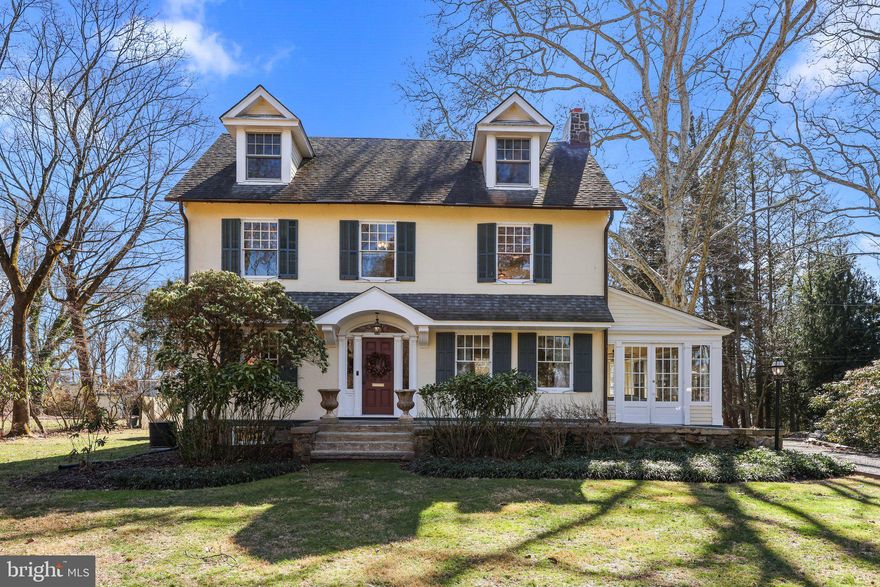 Welcome to this exquisite historic treasure nestled on a lush 1.1 acre lot. This special home was built in 1905 and is impeccably updated with today's modern amenities while maintaining timeless elegance and charm. The quality craftsmanship is evident throughout the home highlighted in the hardwood floors and complemented by plaster walls and intricate architectural details.
The focal point of the gracious front entry foyer is the softly curved staircase with a wrought iron railing.  To the right, French doors open into the expansive living room featuring a handsome stone fireplace, built-in bookcases, and French doors leading to a side sunroom. To the left, French doors lead to the spacious dining room that is filled with an abundance of natural light through the large windows with deep window sills.
The kitchen is a chef's delight, with an exposed brick wall, glass upper cabinets, a granite center island with a prep sink, butcher block counters, and high-end appliances including a Viking range and a Subzero refrigerator. There is a large bay window in the eat-in area and a side door for convenient access to the grill deck. A butler’s pantry offers extensive storage and access to the powder room.
Just off the kitchen is the side entry foyer that welcomes you with a tray ceiling, a large walk-in closet and columns delineating the adjoining kitchen and family rooms. Step into the inviting family room addition, featuring a tray ceiling and a floor-to-ceiling stone wood burning fireplace.  The family room is seamlessly connected by two sets of French doors to an outdoor Pennsylvania bluestone patio which cascades to a second brick patio adorned with a pond water feature and evergreen gardens, creating a serene outdoor oasis.
Upstairs, the second level offers two wings. The front wing includes three bedrooms, two currently being utilized as offices. There is also a full bathroom containing a marble vanity and backsplash as well as a jetted tub/shower.  The expansive back wing provides additional living space including a bonus sitting room, a walk in hall closet, a large laundry room, an updated full bathroom with tile shower and glass door, plus two additional bedrooms, each with French doors connecting to a large sun porch overlooking the rear gardens.
The third level is dedicated to the master suite with a large walk-in closet, a bathroom with a jetted soaking tub, a marble shower with glass door, and a dual sink marble vanity, as well as easy access to a large walk-in attic for additional storage.
The home also has a full unfinished basement for mechanical equipment and storage.  Finally, the oversized two car garage offers an attached 18x11 workshop for DIY projects, plus a large attic area for still more storage.
This home combines luxurious living with historic charm, creating an unparalleled living experience. Close proximity to the historic canal path, shopping, trains and major roadways.  Pennsbury School District.