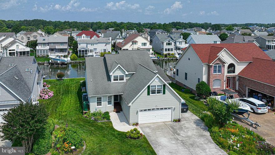 Now is your chance to make beautiful Terns Landing your home address! This three or four bedroom waterfront home has landscaping to be envious of . . .a fish pond with lily pads and waterfall,  fire pit, two Bee-Pollinating floral gardens, multiple raised-bed gardens, and rainwater barrels.  A heated  indoor 5' Deep Endless Pool is included for still water enjoyment or swimming in Lap Mode with adjustable speeds.  After your swim, stroll outside across the  paver patio leading to  the deep water private 25' boat dock with boat lift, davit pole, water and electric, having  direct access to the Isle of Wight Bay!  The interior of this home features Cathedral Ceilings, indirect lighting display areas, hardwood flooring, Family Room, Sun Room & Loft area.  Cooking will be a delight on the commercial grade GE Cafe Double Oven  with 4 gas burners and griddle.  All appliances are upgraded stainless steel, Silestone Countertops, Tile Backsplash, Two Pantries, pull-out Cabinets & mobile counter-height work island.  The extra-wide Double Car Garage includes plenty of storage cabinets, workbench, storage above, and a utility sink.  A separate 15x12 workshop assures that you will have plenty of room for all of your tools and toys!