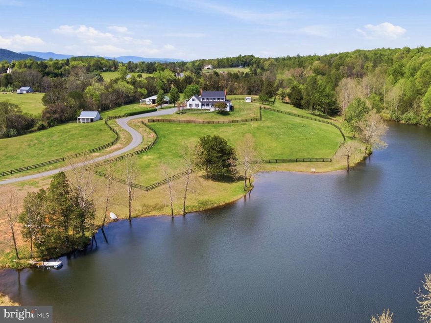 Nestled in the foothills of the Blue Ridge Mountains in historic Amissville, Virginia, Viewmont Farm is an exceptional 23+ acre private estate. Tucked into the rolling hills surrounded by the timeless charm of Virginia’s countryside, framed by mature trees and open skies, the property presents a rare opportunity to enjoy luxury living amid serene rural beauty. The grounds offer peace, privacy and abundant space for both leisure and recreation. Stroll around the private, stocked, spring-fed four-acre lake, the centerpiece of the estate. It features tranquil water views, recreational opportunities and a natural sanctuary that draws a variety of native wildlife. At its heart stands a magnificent 6000+ square foot custom-designed home with a classic wrap-around porch capturing sweeping views of gently rolling pastures, shaded woodlands and the pristine lake. Blending thoughtful design with everyday comfort, this well appointed home offers generously scaled rooms, rich hardwood flooring, crown molding throughout and windows that flood the interior with natural light bringing in the beauty of nature. Designed for both grand entertaining and quiet relaxation, the home includes multiple living spaces. A formal dining room and a living room that boasts a raised hearth fireplace and scenic views. Complete with a cozy wood stove in the family room. The recently updated gourmet kitchen with exquisite quartz countertops and all new appliances is as functional as it is beautiful. The primary bedroom, with an adjoining sitting room and recently renovated private bathroom offers all the amenities of your own personal spa, including heated floors, a towel warmer and a spacious shower.

Equestrians will appreciate the fully equipped, move-in-ready facilities. A five-stall center-aisle barn includes tack and feed rooms, a wash rack, ample storage, and a layout tailored for both convenience and horse well-being. Expansive fenced pastures support grazing and rotation, while a run-in shelter provides flexible turnout options. The land itself is a harmonious mix of open, gently rolling fields and shaded woods, ideal for riding, hiking, or simply enjoying the peaceful rhythm of country life. 

The layout of the land also makes the property adaptable for other farm animals, whether for hobby farming or just enjoying a rural lifestyle.

A versatile workshop and greenhouse provide flexibility, making this estate an inviting choice for anyone seeking space, practicality, and rural beauty.

Whether you’re seeking a private estate, an operational horse farm, or a turnkey homestead, this extraordinary property offers the space, infrastructure, and natural beauty to bring your vision to life. Conveniently located just minutes from Warrenton, Culpeper, and Northern Virginia, this Amissville gem offers easy access to shopping, dining, and commuter routes, pairing timeless elegance with modern convenience in an unforgettable setting.