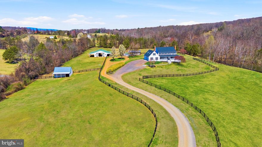 Nestled in the foothills of the Blue Ridge Mountains in historic Amissville, Virginia, Viewmont Farm is an exceptional 23+ acre private estate. Tucked into the rolling hills surrounded by the timeless charm of Virginia’s countryside, framed by mature trees and open skies, the property presents a rare opportunity to enjoy luxury living amid serene rural beauty. The grounds offer peace, privacy and abundant space for both leisure and recreation. Stroll around the private, stocked, spring-fed four-acre lake, the centerpiece of the estate. It features tranquil water views, recreational opportunities and a natural sanctuary that draws a variety of native wildlife. At its heart stands a magnificent 6000+ square foot custom-designed home with a classic wrap-around porch capturing sweeping views of gently rolling pastures, shaded woodlands and the pristine lake. Blending thoughtful design with everyday comfort, this well appointed home offers generously scaled rooms, rich hardwood flooring, crown molding throughout and windows that flood the interior with natural light bringing in the beauty of nature. Designed for both grand entertaining and quiet relaxation, the home includes multiple living spaces. A formal dining room and a living room that boasts a raised hearth fireplace and scenic views. Complete with a cozy wood stove in the family room. The recently updated gourmet kitchen with exquisite quartz countertops and all new appliances is as functional as it is beautiful. The primary bedroom, with an adjoining sitting room and recently renovated private bathroom offers all the amenities of your own personal spa, including heated floors, a towel warmer and a spacious shower.

Equestrians will appreciate the fully equipped, move-in-ready facilities. A five-stall center-aisle barn includes tack and feed rooms, a wash rack, ample storage, and a layout tailored for both convenience and horse well-being. Expansive fenced pastures support grazing and rotation, while a run-in shelter provides flexible turnout options. The land itself is a harmonious mix of open, gently rolling fields and shaded woods, ideal for riding, hiking, or simply enjoying the peaceful rhythm of country life. 

The layout of the land also makes the property adaptable for other farm animals, whether for hobby farming or just enjoying a rural lifestyle.

A versatile workshop and greenhouse provide flexibility, making this estate an inviting choice for anyone seeking space, practicality, and rural beauty.

Whether you’re seeking a private estate, an operational horse farm, or a turnkey homestead, this extraordinary property offers the space, infrastructure, and natural beauty to bring your vision to life. Conveniently located just minutes from Warrenton, Culpeper, and Northern Virginia, this Amissville gem offers easy access to shopping, dining, and commuter routes, pairing timeless elegance with modern convenience in an unforgettable setting.