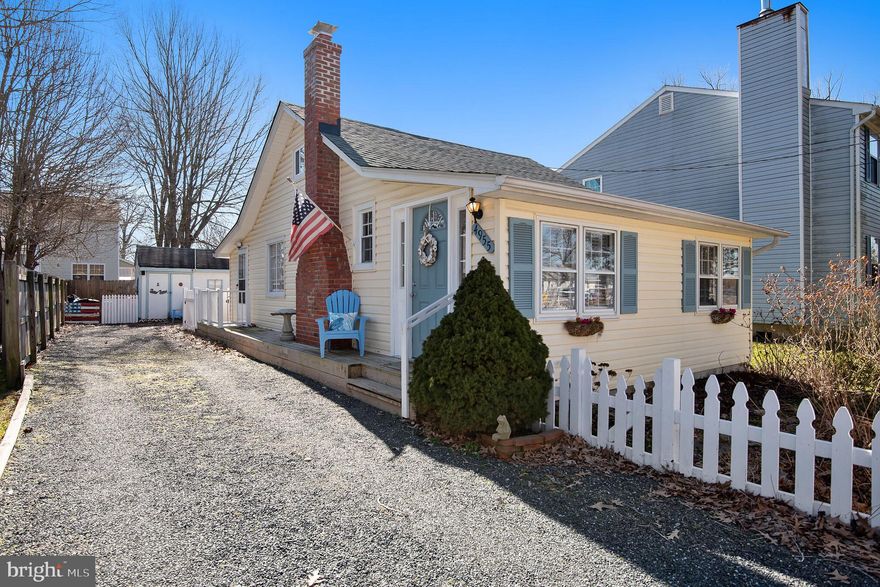 "Pinch me, I'm too cute!" Prepare to fall in love with this incredibly charming 2BR/1BA with loft cottage, enclosed by a white picket fence & offering  water access and views of the water from your driveway. Step inside the sunny foyer & don't miss the wainscoting, bench seating w/cubbies & hall closet. As you proceed into the home, you will love open layout and rustic hardwood floors throughout.  Imagine cuddling up with a book by the painted brick wood stove fireplace with mantle, flanked by built-in shelving & windows.  As you proceed into the home, an arched entrance leads you to the dining room and kitchen. Filled with natural light, the kitchen has a window, back door to side porch & patio, as well as a pantry with additional storage and a stackable washer/dryer.  An open staircase leads to the partially floored attic & loft with hard surface flooring -- currently utilized for additional bedroom & playroom. The fully fenced flat backyard has a covered brick patio & a large wooden shed.  Situated in Avalon Shores, surrounded by the Western River, just off the Chesapeake Bay, with community dock, playground, swimming area, & boat ramp. Enjoy kayaking, canoeing, boating, sailing, SUP, crabbing, nearby beaches, playgrounds & hiking trails ...and everything else Shady Side has to offer!  ONLY 45 minutes to DC! No Bay Bridge or RT 50 traffic! Only 20 minutes to Edgewater (with theaters, shops, restaurants), and just 25 minutes to downtown Annapolis.  You'll LOVE life in the Chesapeake Bay area! A FANTASTIC weekend get-away cottage or cozy year-round home!