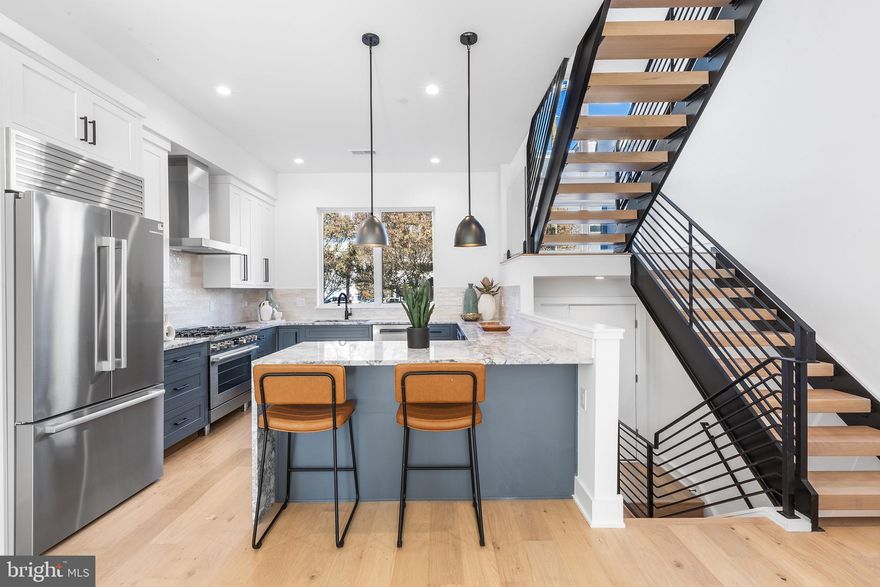 Now offering 4 bedroom layout! Welcome to Liberties Court, an exceptional new construction townhome development in the heart of Northern Liberties, one of Philadelphia’s most vibrant neighborhoods. This luxury home offers everything you’ve been looking for—modern design, top-tier amenities, a private elevator, 2-car garage, and unparalleled convenience. Featuring 3 or 4 spacious bedrooms, 3-4 full bathrooms, and 2 half bathrooms, this residence is designed with both style and comfort in mind. The ground-floor entrance welcomes you with convenience and functionality, offering direct access to your attached two-car garage via a covered driveway—a rarity in urban living. This level also includes a full bathroom and a fully finished flex space with soaring ceilings, ideal for a home office, fitness area, or guest suite. From here, step into your private elevator, which provides seamless access to every level of the home. On the main living floor, you’ll find the heart of the home: a meticulously designed kitchen outfitted with high-end Bosch appliances and a sleek Zephyr Roma series range hood. The kitchen seamlessly blends elegance and functionality, making it perfect for both everyday cooking and entertaining. Adjacent to the kitchen is a large dining room and living room, offering an open and airy space ideal for gatherings. Through the sliding glass door, enjoy easy access to a beautiful inner courtyard—perfect for relaxing or dining al fresco. A half bathroom on this level adds convenience for both residents and guests. The second floor features two spacious bedrooms and a full bathroom, each thoughtfully designed with large closets providing ample storage for a seamless living experience. This level also features a spacious laundry room for added convenience. The primary bedroom floor serves as your private retreat, complete with a large walk-in closet and a spa-like ensuite bathroom with double vanities, a soaking tub, and a glass-enclosed shower—your perfect sanctuary at the end of the day. Throughout the home, thoughtful details elevate the living experience, from the private elevator to the top-floor entertaining lounge, tailored for comfort and social gatherings. This level features a wet bar, a half bathroom, and access to two outdoor spaces. Step through sliding glass doors onto a private terrace, ideal for intimate get-togethers, or take the stairs to the expansive roof deck boasting unobstructed 360-degree views of the Philadelphia skyline—a breathtaking backdrop for larger events or quiet evenings under the stars. With three outdoor spaces, including the peaceful courtyard, this home offers abundant options for relaxation and entertaining. Situated in dynamic Northern Liberties, Liberties Court places you moments from the city’s best restaurants, cafes, and boutique shops, as well as local favorites like The Piazza and North Bowl. For commuters, quick access to I-95 and the Market-Frankford Line ensures seamless travel to Center City and beyond. Homes in Liberties Court offer a rare combination of luxury, practicality, and location.