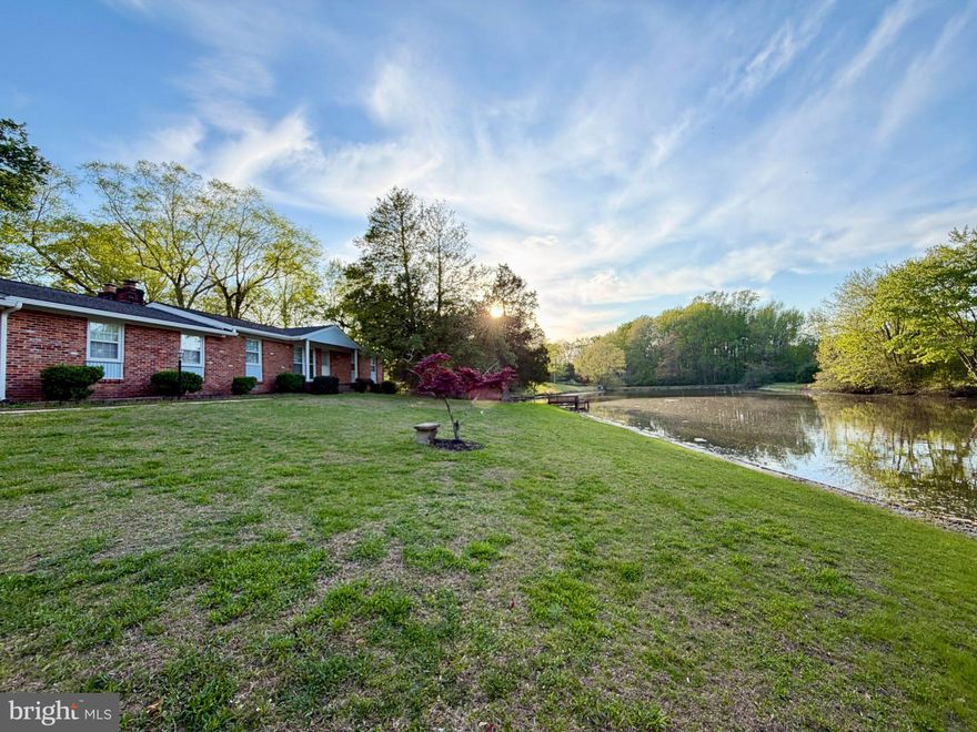 This exquisite ranch-style home offers a unique blend of luxury and tranquility, perfectly complemented by its stunning water features. Spanning over 2.41 acres, this property boasts an impressive 302 feet of private pond frontage, creating an idyllic backdrop for both relaxation and recreation. As you approach the home, the charming all brick exterior invites you in, hinting at the warmth and comfort that awaits inside. The spacious layout encompasses three well-appointed bedrooms and two full bathrooms, providing ample space for both entertaining and unwinding. The heart of the home features two inviting fireplaces, perfect for cozy evenings spent with loved ones, while the expansive living areas in the sunroom and rec room seamlessly connect to the outdoor spaces, allowing for effortless indoor-outdoor living. Step outside to discover your own private oasis. The tranquil pond not only enhances the beauty of the landscape but also offers a wealth of recreational opportunities. Enjoy leisurely afternoons fishing from your private dock or embark on peaceful canoe and kayak adventures, all just steps from your door. The gentle sounds of water lapping against the shore create a soothing ambiance, making this property a true retreat from the hustle and bustle of everyday life. The expansive lot provides plenty of room for pets and outdoor gatherings, whether it's a summer barbecue or a quiet evening under the stars. Imagine sipping your favorite beverage on the gazebo and large deck, surrounded by the natural beauty of the water and lush greenery. Park in the attached 2 car carport and utilize the 2 car detached garage as a creative workshop or artistic studio. This home is not just a residence; it's a lifestyle that embraces the joys of nature and the comforts of luxury living. With its prime location in Hughesville and exclusive water access, this property is a rare find that offers both privacy and a sense of community. Experience the perfect blend of elegance and relaxation in this remarkable home, where every day feels like a vacation. Embrace the opportunity to create lasting memories in a setting that truly feels like home.
