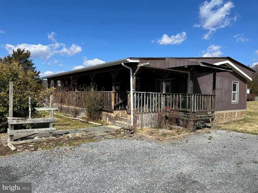 Ready to move in 3 bedroom, 2 bath house on a double lot. Interior has been updated. Carpet throughout. Washer and dryer included.  Large front porch with storage on one end.  Unfinished added room with deck off of it. Double garage. Fenced back yard with large shed. House is set on piers on top of a slab.
