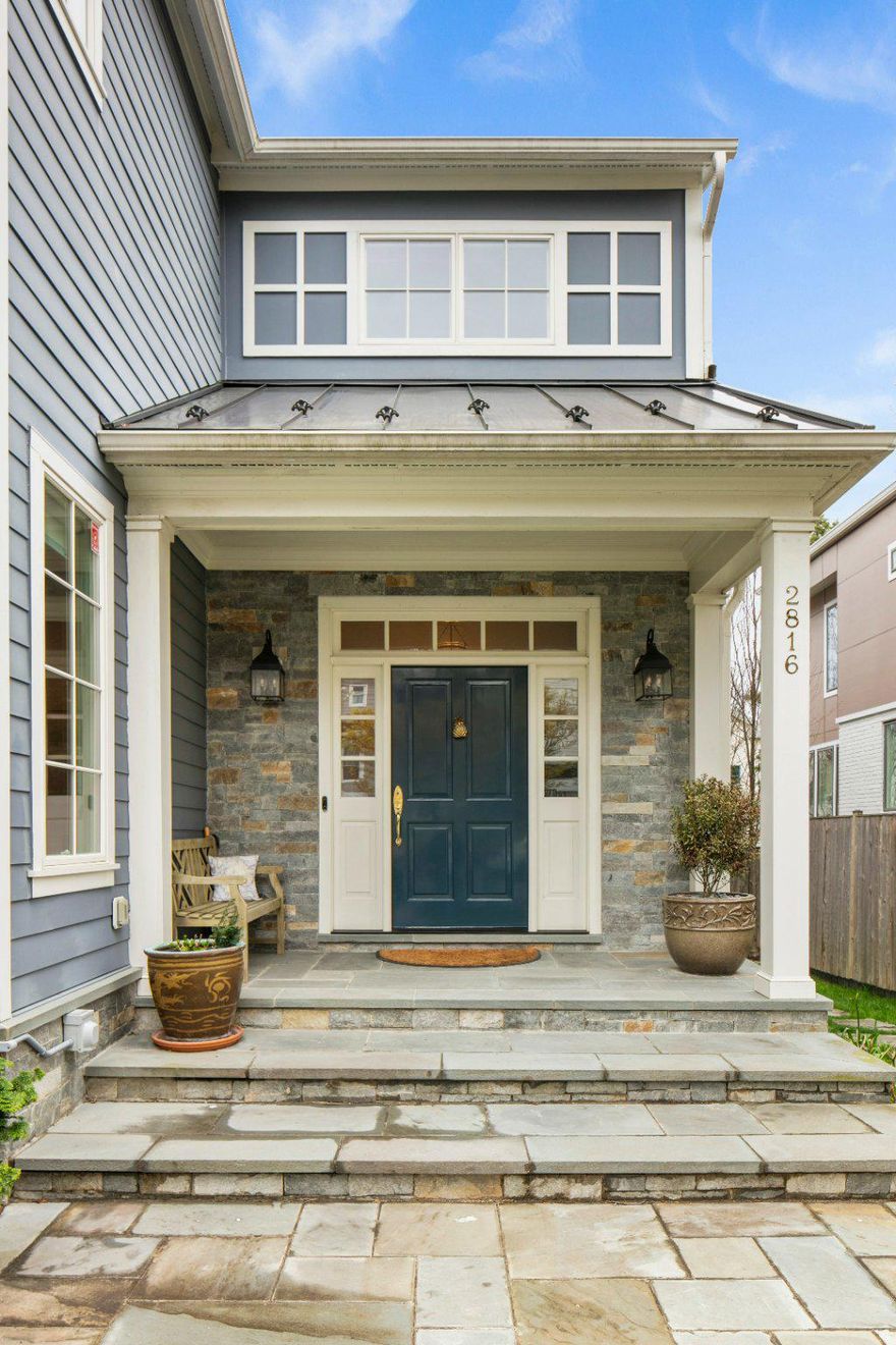 Welcome to 2816 1st Road N, a thoughtfully designed custom home built in 2017 by BCN. This Lyon Park residence pairs refined craftsmanship with a warm, highly livable design.

Set in one of North Arlington’s most sought-after neighborhoods, Lyon Park is known for its tree-lined streets, strong sense of community, and exceptional accessibility. Residents enjoy walkable proximity to Clarendon and Ballston, along with convenient access to the Orange and Silver Line Metro, major commuter routes, and Washington, DC, just minutes away.

This like-new home was designed with intention at every turn. Nestled among lush gardens and mature landscaping, the property is centered around a stunning cherry tree. Wisteria-lined fencing and thoughtfully placed trees create a private, serene setting.

The main level features a welcoming, timeless foyer, a private office with built-ins, and a main-level bedroom with a full bath ideal for guests or flexible living. The chef’s kitchen includes a large island, Wolf and Sub-Zero appliances (including a built-in coffee maker), and generous pantry space. It opens seamlessly to the family room, dining area, and sunroom. A double-sided wood-burning fireplace anchors these rear living spaces, where floor-to-ceiling windows frame beautifully landscaped views. An oversized side porch leads to a functional mudroom with additional pantry storage, a sink, and a dog wash station.

Upstairs, you’ll find three bedrooms and three full baths, including a spacious primary suite with an adjoining sitting room- perfect for a home office, studio, or nursery.

The lower level is equally well-appointed, with custom built-ins throughout. It includes a sound-insulated recreation room designed for music or media, a dedicated exercise room, a half bath, and a workshop with double-door access to the backyard, ideal for bikes and outdoor gear.

This is a truly special Arlington home and you’ll feel it the moment you arrive. A lovingly maintained, lightly lived-in property, ready to welcome you home.