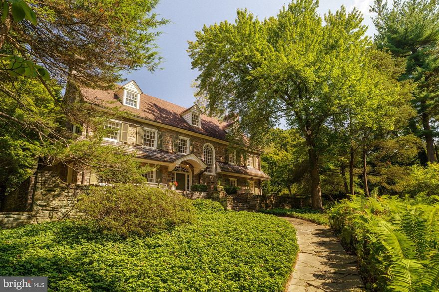 Welcome to this grand early 20th-century Colonial estate—an exceptional offering on one of West Mount Airy’s most coveted park blocks. Set on nearly an acre and bordering the Wissahickon, the home combines timeless stone architecture with thoughtful renovations by a noted architect, Addison H. Savery, showcasing custom detailing throughout.Behind the tree-lined frontage, privacy and serenity unfold with stone terraces, mature gardens, and a sparkling saltwater pool—all just minutes from the shops and restaurants of both West Mount Airy and Chestnut Hill. Inside, three levels (plus basement) offer over 5,000 square feet of living space with five bedrooms, five full baths, and a powder room. The gracious entry foyer with its curved staircase sets the tone, leading to a formal living room and dining room—each anchored by Mercer tile fireplaces. A sun-filled gourmet kitchen opens to a glass-wrapped sunroom with new French doors, alongside a den, mudroom, and powder room. The second floor hosts three en-suite bedrooms, a bonus room, a laundry room, and an additional full bath. The third floor offers versatility: a guest apartment or family retreat with two bedrooms, a living area, office, and full bath. Additional highlights include a full unfinished basement and a two-car garage. This is a home that balances classic grandeur with modern livability—a private retreat on the Wissahickon, yet seamlessly connected to all the best of Philadelphia. https://fliphtml5.com/ivrcr/nzyt/