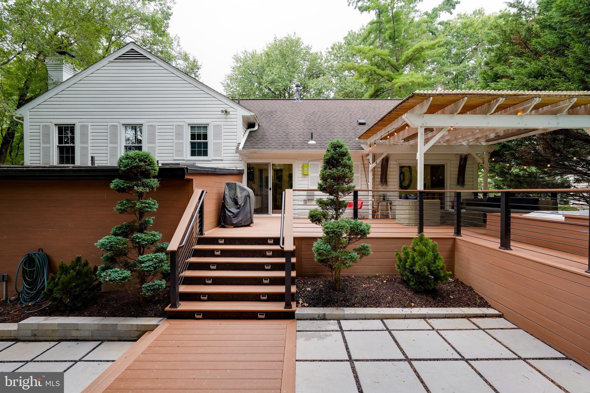 Fall in love with 929 Farm Haven Drive, a one-of-a-kind reimagining of a home in the sought-after North Farm neighborhood of Rockville. Thoughtfully expanded and expertly renovated, this 5 bedroom, 4.5 bath, four-level residence lives like a private retreat! With nearly 4,000 SF, every space is designed for comfort, functionality, and effortless living.
Located on a quiet, tree-lined street, the home makes a striking first impression with its mature landscaping and welcoming front porch. Inside, the main level features a bright living room with cathedral ceilings, a spacious dining area, and an updated kitchen offering abundant workspace and storage.
Just a few steps off the main level, a light-filled family room with fireplace, powder room, and an extra-large rec room (with its own side entrance—ideal for a home gym) provide the ultimate in flexibility. Adjacent is a private home office, perfect for remote work or creative projects. One of the home’s most special features is the Primary Suite addition, tucked away for ultimate privacy. This zen-like sanctuary includes built-ins and a spa-inspired primary bath with a double vanity and oversized shower.
Upstairs, you’ll find a guest bedroom with custom built-in closets and a renovated en-suite bath, plus two additional generously sized bedrooms and a modern hall full bathroom.
The lower level of the home includes a fifth bedroom with en-suite bath, a laundry room, generous storage space, and an additional flex room—perfect as an art studio, yoga space, or hobby room.
Step outside from the living room, kitchen, or primary suite and find yourself in a true outdoor oasis. The multi-tiered backyard features a partially covered deck with built-in heaters and garden lights, a newly installed hot tub, and a lower patio with fire pit and beautifully integrated landscaping and hardscaping—designed for both everyday enjoyment and unforgettable entertaining.
This home offers a rare combination of thoughtful design, warm character, and modern convenience. Don’t miss the opportunity to make it yours!