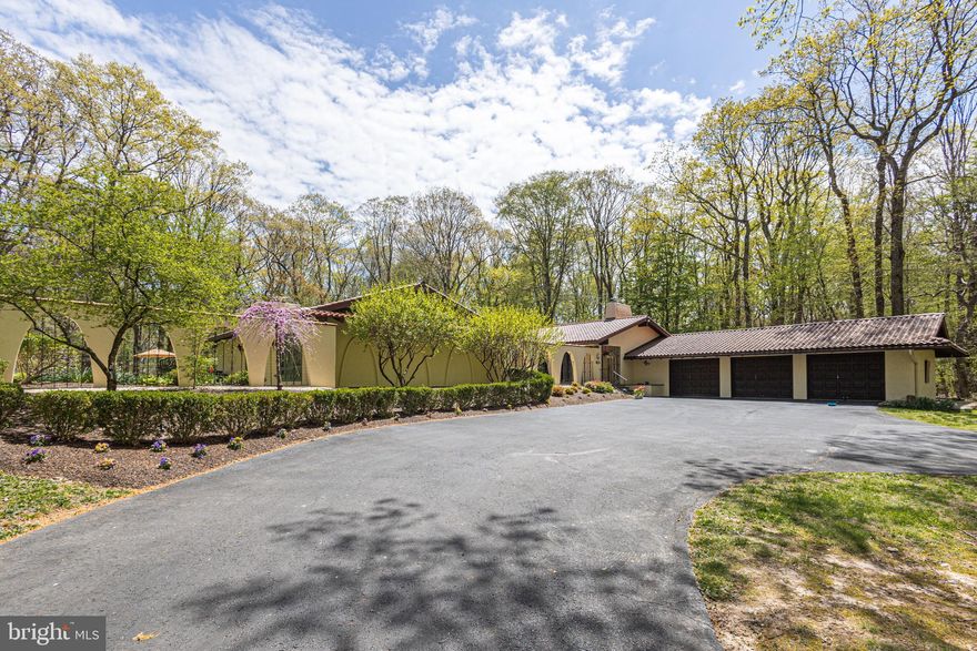 Rarely offered villa style one floor living in the heart of bucolic Solebury Township. This California Contemporary ranch offers Spanish revival architectural elements including tiled roof, central courtyard with water fountain, custom windows throughout providing natural light and private views of nature and the wooded backdrop from every room. Fantastic, redesigned space showcasing a beautiful Gourmet Kitchen with custom tiger wood maple cabinets, vaulted ceilings, 6 burner Thermador range, wine refrigerator and an oversized island that flows into a back butler’s pantry area perfect for entertaining. The great room is both comfortable and spacious, offering a cozy wood burning fireplace & large windows and doors that lead to both the courtyard and pool areas. 4 Bedrooms including a lovely primary that boasts a wood-burning fireplace, vaulted ceiling, and spacious closets. The renovated primary bath is a serene escape with a classic claw foot tub, 2 separate vanities with custom cabinetry and floor to ceiling windows. Versatile fourth en suite bedroom can serve as a perfect guest suite, au pair quarters or teen room. The finished lower level introduces additional living space and features recessed lighting, custom built-in wine storage, wet bar, recreation space, media area, half bath and walk-up access to the renovated pool. Thoughtfully designed and maintained, this home features wonderful additional amenities including a whole house generator, professional closet systems, custom cabinetry throughout, renovated back porch that includes Azek wrapped columns, trim and gorgeous limestone tile, governor’s driveway and 3 garage bays. Enjoy luxury, comfort and privacy within a neighborhood setting in New Hope- Solebury schools. Less than 5 miles to the heart of New Hope Borough and Peddler’s Village.