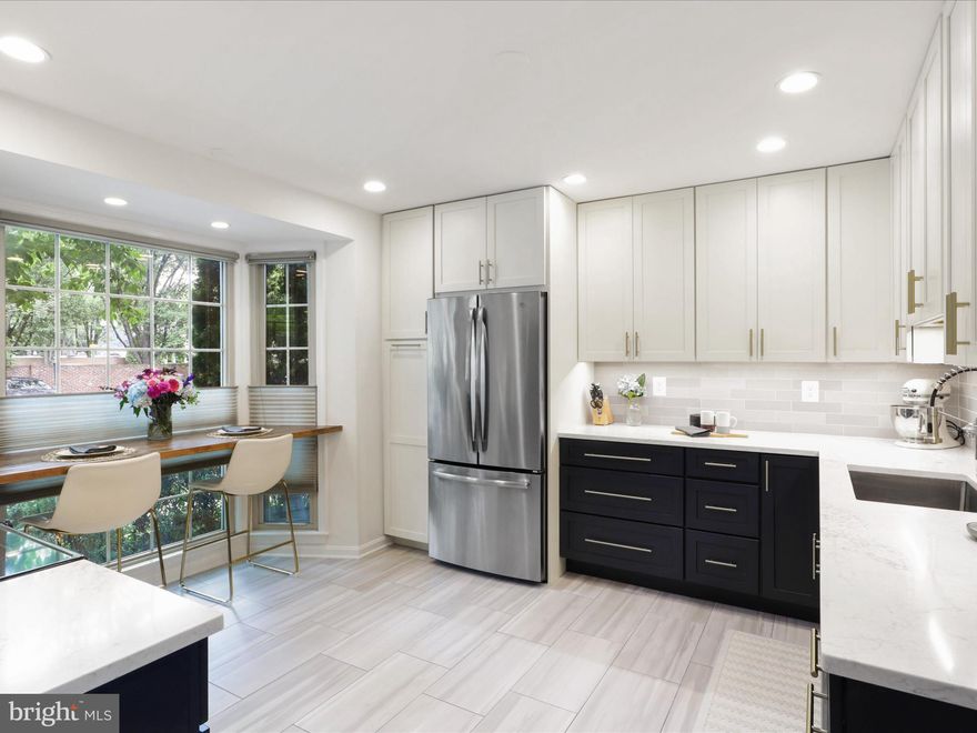 Presenting this beautifully maintained and updated private End Unit 3BR / 2BA / 2 1/2 BA 2,463 Sq. Ft. Three Level Townhome with Two Unreserved Parking Spaces in the desirable Wolftrappe Square neighborhood, centrally located in the Town of Vienna!  Upon entry to home, you are met by a tile flooring foyer, large step-in coat closet and updated powder room that leads directly to the recently renovated designer kitchen (2022), with a partially removed wall that provides a more open concept floor plan.  Kitchen features two tone white and navy cabinets with champagne bronze hardware, tile flooring, quartz counters, stainless appliances, recessed lighting and a bar eat-in space with large bay window with window treatments that adds light to the main level. Walnut hardwood flooring and crown molding throughout the dining room, that includes custom light fixture, bar space and added white cabinetry for additional storage. Expansive living room also with walnut flooring and crown molding, a fireplace that conveys as is and sunny windows that overlook the large and private fenced backyard.  Upstairs has three well sized bedrooms with window treatments, including the primary bedroom that offers walnut floors, ceiling fan and updated primary en-suite primary that includes tile flooring, vanity, storage and stand-in shower with tile and glass door. Second bedrooms are carpeted and are generously sized secondary rooms with closets and share a second renovated full bathroom with tile flooring, vanity and soaking tub/shower combination with tile. Basement is 3/4 finished and includes a carpeted room that can be used as a flex space for office, den or en-suite bedroom (not a taxable bedroom), additional living room space with laminate flooring, second fireplace that conveys as is, bar area with sink, storage room with Carrier AC and Gas Furnace installed in 2019, second refrigerator and washer/dryer.  Basement is also a walk-out with direct exterior access to the backyard.  Outside, you are met by a 20x20 ground level deck for morning coffee or exterior entertaining, with the yard past the deck including manicured landscaping, shed and fence. Neighborhood is near many Fairfax Connector bus stops for public transportation and is adjacent to 123, with quick access to Tyson’s 495 and 66 to get into DC. Across the street is the popular Clarity restaurant and many other restaurants, retail and grocery stores in the area.  This is the perfect location at a hard to find price in Vienna, do not miss it!