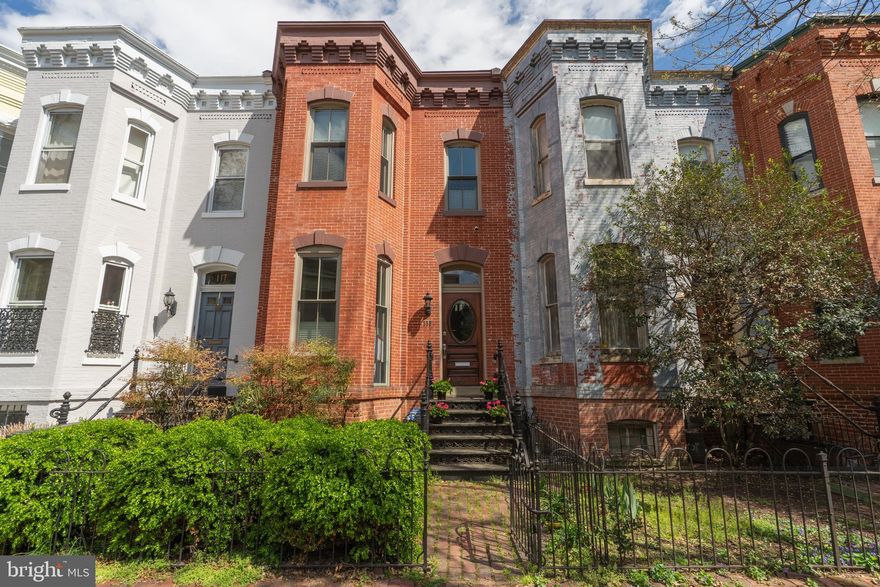 Built at the turn of the century and ideally located just blocks from the Capitol, this elegant brick row house offers beautifully appointed interiors along with the rare convenience of gated parking.

The gracious living and dining rooms showcase original marble fireplaces, soaring ceilings, and exquisite millwork—creating an inviting setting for both everyday living and sophisticated entertaining.

The beadboard-paneled kitchen flows seamlessly into a charming breakfast room and opens to a newly renovated deck and gated patio, providing wonderful indoor-outdoor connection.

Upstairs, two spacious primary suites feature ensuite baths, generous walk-in closets, and access to a roof deck overlooking the serene, tree-lined courtyard below.

The lower level includes a comfortable family room, an additional bedroom, full bath, and ample storage, with both interior access and a separate exterior entrance from the patio.

Lovingly maintained, the home benefits from numerous recent improvements, including new windows, HVAC system, roof deck, main-level decking, and steel railing system.

Perfect location with nearby parks, Eastern Market, Navy Yard restaurants and metro/Amtrak access.