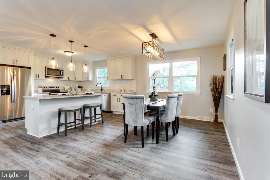 Lakefront! Gorgeous renovated  4 bedroom, 3 full bathroom home featuring a gourmet kitchen with white soft-close cabinets, granite countertops, tile backsplash, stainless steel appliances, recessed lighting and large kitchen island.  Open concept main living area with beautiful views of the lake!  Luxury vinyl flooring throughout, new lighting and freshly painted. Spacious master bedroom with ensuite bath with beautifully tiled shower. The lower level offers a second living area complete with woodburning stove, sliding door to spacious yard leading to the waterfront, an office, full bathroom, the 4th bedroom and a large laundry/storage/utility room with a door to the yard. The back yard delights with glorious views of the lake, a large shed for storage and space to play and entertain. New windows and doors.  New hot water heater. Conveniently located to shopping, restaurants, movie theaters, parks and commuter routes (10min! to NAS PAX River). This beautiful lakefront fully renovated home won't last long!