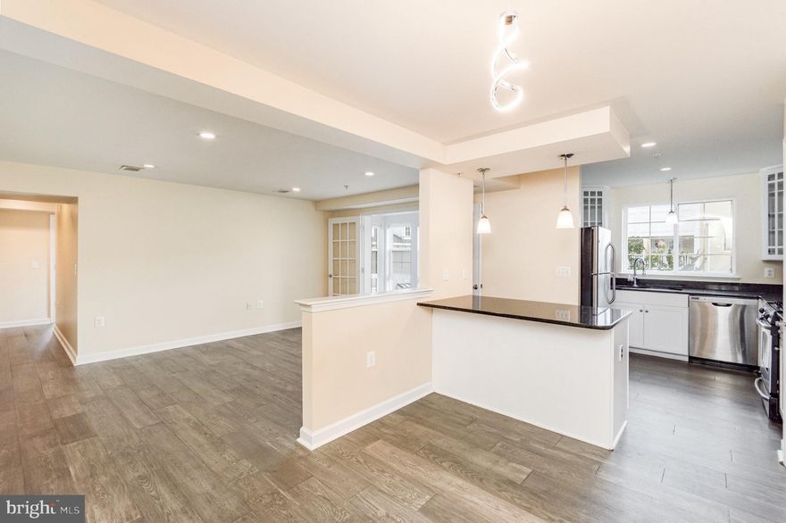 Beautiful 2-bedroom, 2-bathroom condo for rent in sought-after West Village of Shirlington! This spacious home offers modern updates, abundant natural light, and a fantastic location with access to incredible community amenities. Step inside to find a welcoming entry with a large coat closet and new hardwood flooring (2022) that flows throughout the home. The dining area is accented by a stylish modern light fixture and opens to the kitchen, which features a granite countertop peninsula with pendant lighting, stainless steel appliances including a newer microwave (2022), a pantry closet, and crisp white cabinetry. The spacious living room features recessed lighting, a utility closet, and a French door leading to the bright sunroom, complete with tile flooring and courtyard views – a perfect spot to relax or work from home.

Down the hallway, a linen closet offers extra storage, and the hall bathroom features a large vanity, sparkling white tiled walk-in shower, and tile flooring. A laundry closet with a full-size stacked washer & dryer makes everyday living a breeze. The 2nd bedroom includes recessed lighting and a generously sized closet, while the primary suite boasts recessed lighting, a large walk-in closet with built-in organizers, & an ensuite bathroom with an oversized vanity, extra linen shelving, tile flooring, & a sparkling white tiled shower with soaking tub illuminated by recessed lighting.

The West Village of Shirlington neighborhood offers direct access to S Four Mile Run Drive, the W&OD Trail, & Barcroft Park. Enjoy easy access to shops and dining at The Village at Shirlington, plus quick connections to I-395 for commuters. Community amenities include outdoor grilling areas, a 24-hour gym, business center, & a MASSIVE pool – plus a FREE shuttle to the Metro!