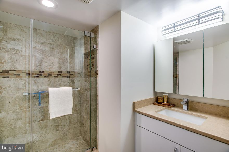 Stunning two bed/ two bath unit in the Chase building in DT Bethesda across from the metro. The unit has been completely renovated with high end new SS appliances (Viking/KA), granite counters, Washer/ Dryer in unit, brand new bathrooms (Grohe/Kohler/Toto), high quality tile, wood floors and much more. Building has 24 hr front desk, pool, gym, hot tub tennis and more. Garage parking is included in this low price. Management is also on site. Bethesda's top restaurants, cafes, bike trail are just outside your door! Walk Score of 99.