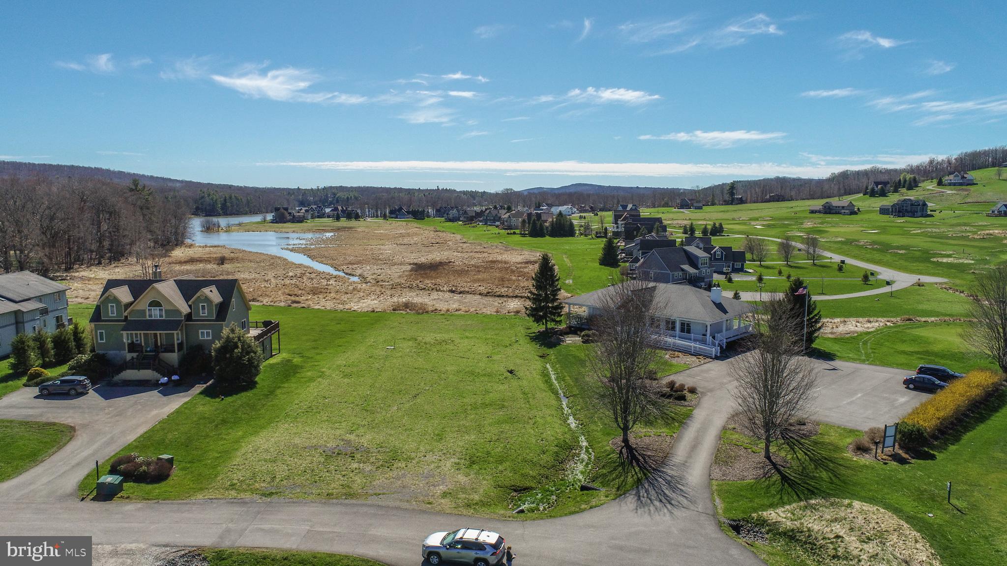 Premium lake view/front lot with lake access located in the prestigious Waterfront Greens community. IMPROVED PROPERTY with well, public sewer grinder pump and ERU in place. Enjoy all of the amenities Waterfront Greens offers including a par 3, 9 hole golf course, tennis courts, mini golf, catch & release fishing pond and club house. Swim, fish, kayak and canoe at the Waterfront Greens community access. This property is ready for your dream home!