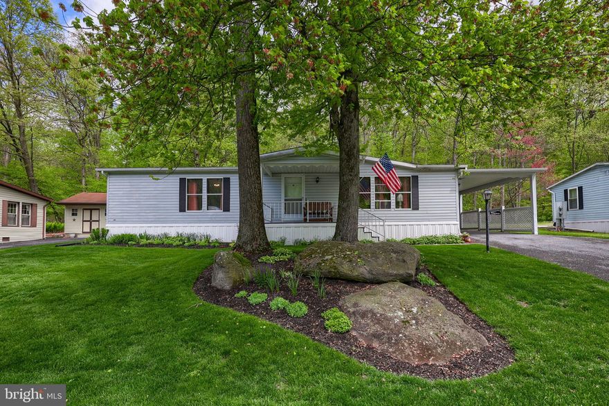 Welcome to 36 Maple Avenue! This home is located in the desirable Gretna Springs 55+ Community.  With 2 bedrooms, 2 full bathrooms, and over 1,200 sq ft, this home features a large living room that flows into the kitchen and dining area which overlooks the private backyard. The primary bedroom has an attached full bathroom, and there is an additional bedroom and an additional full bathroom. The covered back deck is perfect for relaxing or entertaining outdoors! There is also a shed on the property which offers additional storage. This home is centrally located off Route 72, just minutes from the PA Turnpike and Route 322. Lot rent includes water, sewer, trash, and access to the community center. Don't miss this opportunity, schedule your showing today!