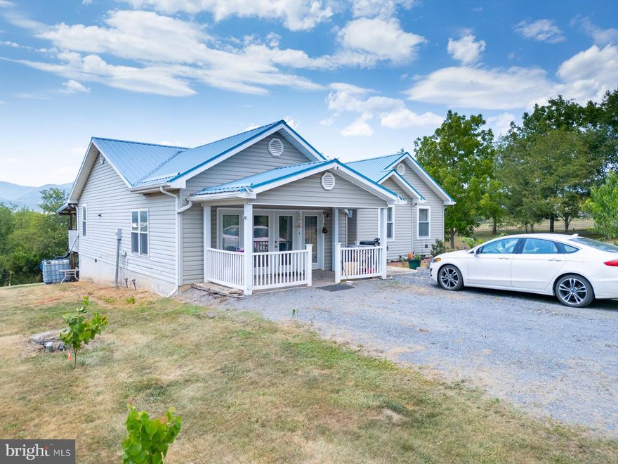 ***MOTIVATED SELLER, JUST REDUCED BY $30,000!!!***Discover the perfect blend of country charm and modern convenience in this beautiful 3-bedroom, 2-bathroom home, built in 2001. WIth mountain and farm views of the valley and nestled on 2.53 acres of usable land, this 2,708 sq ft residence offers a unique opportunity for those with homesteading aspirations or anyone seeking tranquil living. With ample living space, the home provides room for family life and entertaining, featuring a separate dining room perfect for gatherings. Enjoy the luxury of modern upgrades, including a brand-new metal roof (2019), a state-of-the-art complete Bosch A/C unit including the outdoor unit and air handler (2020), and a new stove (2022). All appliances are top-of-the-line stainless steel, complementing the elegant granite countertops in the kitchen.

The interior showcases tile and hardwood floors throughout, ensuring durability and easy maintenance. The master bedroom is a true sanctuary, complete with a jet tub and stand-up shower. The recreation room, equipped with a bar area and stainless steel sinks, is ideal for hosting friends or transforming into your dream man cave. Outside, embrace a sustainable lifestyle with your very own orchard, featuring cherry, plum, peach, pear, and apple trees, along with grapevines—truly a gardener’s paradise. Conserve water with a fully operational water catchment system. A spacious shed conveys with the property, providing excellent storage or workshop space.

Enjoy the freedom of a relaxed Homeowners Association, allowing you to truly make this property your own. Just an 8-minute drive from Moorefield, the Hardy County seat, you’ll find all essential amenities including Walmart, grocery stores, Tractor Supply, fast food, and other restaurants. The South Branch of the Potomac River is a mere 6 minutes away, perfect for canoeing and rafting. Nature enthusiasts will appreciate being only an hour from Dolly Sods Wilderness and 50 minutes from Seneca Rocks. The Trout Pond Recreation Area and George Washington National Forest are just 45 minutes away.

Moorefield boasts a low crime rate and a wealth of community-oriented events, making it an ideal place to raise a family. For those occasional shopping sprees or city adventures, Winchester, VA, is about an hour away, and Washington, DC, is approximately a 2-hour drive. Don’t miss the opportunity to own this exceptional property that offers the best of both worlds—peaceful country living with modern comforts and easy access to all you need. Make this charming home yours today!