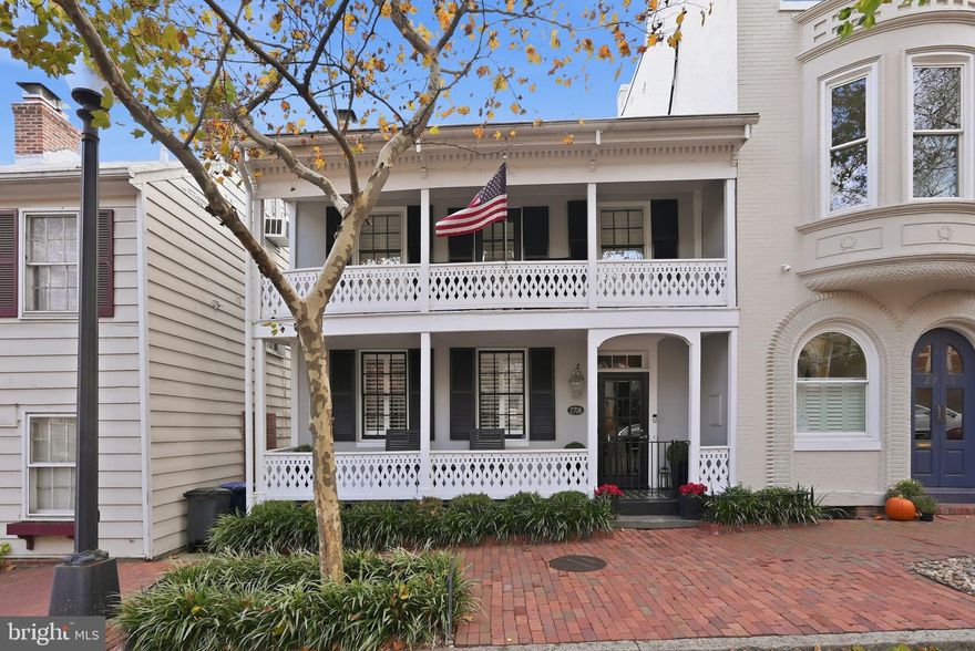 BEAUTIFULLY UPDATED HOME IN GEORGETOWN’S EAST VILLAGE  WITH 2-CAR PARKING! Steeped in history and beautifully renovated for modern living, 2708 P Street NW is a rare Georgetown jewel dating back to the 1790s. Distinguished curb appeal begins with its iconic Louisiana-style two-story front porches, freshly restored floorboards, custom ironwork, and newly installed architectural lighting that highlights the home’s historic façade at night. Boasting 3 Bedrooms, 3.5 Bathrooms, and over 3,100 sqft across 3 stories of beautifully renovated living spaces, this gorgeous home features triple exposures and large windows that fill the home with an abundance of natural light at every turn, while six fireplaces (four converted to remote-controlled gas) anchor the home with timeless charm. A comprehensive 2019 renovation introduced top-tier Kitchen appliances, custom stone accent walls, bespoke millwork, designer lighting, modern stair railings, curated window treatments, and more. The Kitchen and main living spaces are framed by three stories of insulated, floor-to-ceiling glass doors, flooding the interiors with natural light and creating a seamless indoor-outdoor flow ideal for entertaining. Upstairs, the Primary Suite is a true retreat, featuring oversized windows, a fireplace, custom closets, and a fully renovated spa bath complete with heated floors, upgraded fixtures, and its own fireplace. Additional rooms include the second Bedroom which offers access to the second story front porch plus a flexible bonus room perfect for a home office or sitting room. The Lower Level offers exceptional versatility with a third Bedroom and Bath, an expansive Family Room with walkout access, and a secondary Kitchen/storage area appointed with new flooring, custom cabinetry, and granite counters. The private rear Patio has been completely redesigned with new landscaping and hardscaping, and features a built-in gas grill, custom fountain, and integrated outdoor speakers—an inviting extension of the home’s living space. Two-car parking, accessed from Poplar Street, is an extraordinary Georgetown luxury. Additional upgrades include an eco-friendly A/C system, updated water lines, new gutter system, smart washer/dryer, new boiler valve system, exterior downlighting, new fencing and gates, and a state-of-the-art security camera and lighting system. Meticulously restored and thoughtfully enhanced, this exceptional residence offers timeless Georgetown character with every modern comfort just moments from the neighborhood’s finest dining, shopping, and waterfront. OPEN HOUSE SATURDAY, 3/7 & SUNDAY, 3/8 from 2-4PM!
