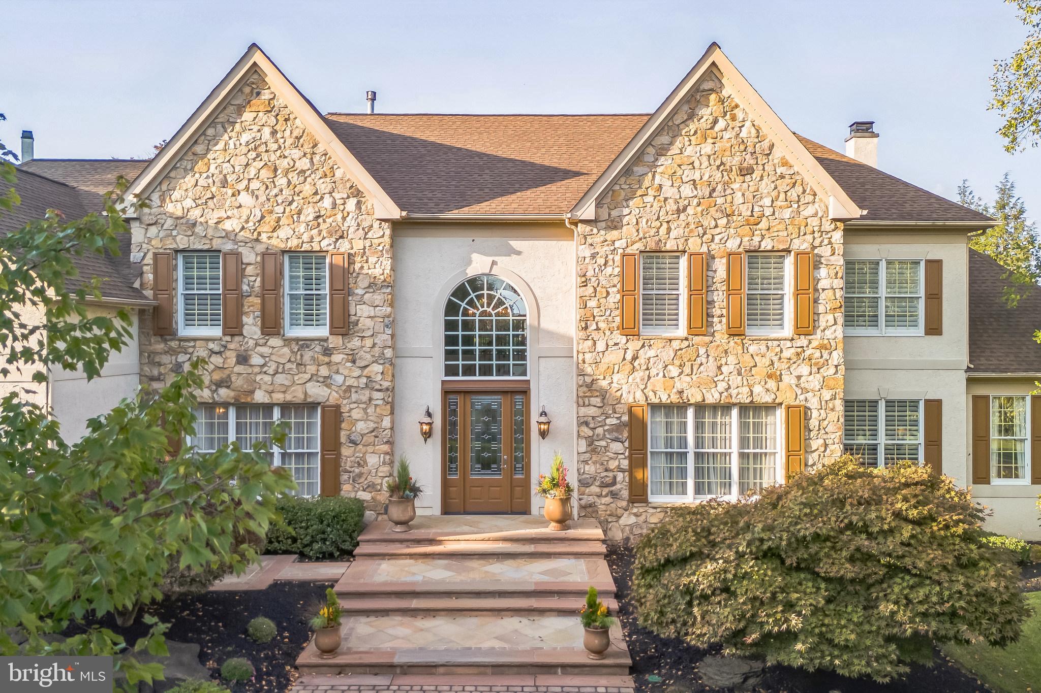 Welcome to the prestigious community of River Crossing, nestled in the heart of New Hope, Pennsylvania. River Crossing is known for its timeless charm and architectural beauty, home to some of the most iconic residences in Bucks County. Legacy Properties is honored to present what is truly the crown jewel of this idyllic neighborhood: 55 Woodside Lane. This executive home offers unmatched elegance and one-of-a-kind custom features not found in any other home within the community. As you arrive, you're greeted by a meticulously manicured lawn and breathtaking landscaping that spans nearly two acres, an outdoor masterpiece that would impress even the most discerning landscape designers. A tree-lined, double-wide governor’s driveway leads you to the entrance of this grand home. Step out onto an expansive custom stone entrance and take in the beauty of the eight-foot-tall, three-point locking custom front door, a unique architectural feature exclusive to this home in River Crossing. Inside, custom hardwood flooring flows throughout both levels. The grand foyer welcomes you with a stunning new crystal chandelier, setting the tone for the sophistication that lies within. A custom artisan-crafted staircase adds to the striking beauty of the entrance. From the center hall, you’ll enter a gourmet chef’s kitchen, ideal for hosting large gatherings. An impressive two-story breakfast area creates an airy, light-filled space perfect for casual dining. Adjacent to the kitchen is a formal dining room that comfortably seats up to twelve guests, located just beyond the butler's pantry ideal for elegant entertaining. The large family room, expanded to approximately 900 square feet, boasts large windows and skylights that fill the space with natural light. Enjoy cozy evenings by the stone gas fireplace or entertain at the custom bar with built-in ice maker and refrigerator as the centerpiece of this stunning room. Step into the tiled sun-filled conservatory, a perfect space for relaxing with a drink or enjoying a game of billiards. From there, enter the fully furnished private office, included in the sale of the home. The elegant living room completes the main floor. Before heading upstairs, don't miss the fully finished basement, which elevates the concept of a recreation space. This expansive level includes a full kitchen with custom cabinetry, wine and beverage refrigerators, an ice maker, and a dishwasher ideal for hosting large events. This floor continues with room for various activities including adult games, a gym, a TV viewing area, an entertainment area and more. A full bathroom featuring a ribbon onyx tiled shower, completes this incredible lower level. Outdoors, enjoy a resort-style oasis. The Arcadia multi-zone louver roof system with lighting and ceiling fans provides all-weather comfort, while the custom Anthony & Sylvan pool, complete with rock waterfall and spa, is surrounded by lush gardens and multiple lounging areas. The three-car garage completes the first level. On the second floor, discover the expansive and private master suite, featuring a cozy sitting area ideal for reading or watching your favorite show. The spa-like master bathroom includes dual vanities,with Quartzite a jetted tub, a private toilet room and a custom tiled shower. with Quartizte surround and showered seat. This level also includes four additional bedrooms, each with adjacent full bathrooms, one of which features another jetted tub.55 Woodside Lane is an extraordinary home that truly has it all. To schedule a private tour, please contact me directly.