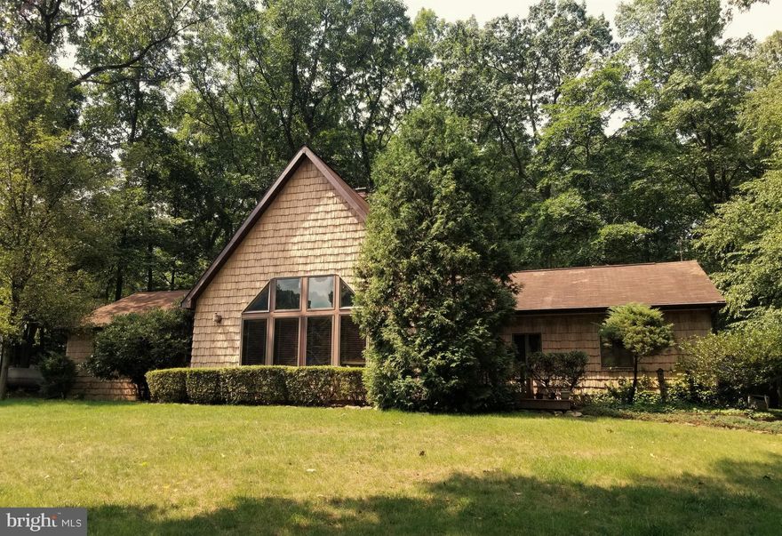 Tranquility at its best...park like neighborhood with mature trees, surrounded by mountains. This home was so tastefully planned out, with its open floor plan, step into the living room to see the 2 story stone fireplace, that opens up into a beautiful gourmet kitchen, with a gas stove inset in the the kitchen island, with lots of custom cabinetry and space for a large dining room table, beamed ceiling and lots of counter space. Leads out to a Florida room with French doors, to enjoy the seasons as they change, or head out to one of the 2 decks. Main bedroom has lots of closet space, with a separate bathroom, and  soaking tub, that has it's own doorway to the other deck.  Second story bedroom loft. The lower level is finished, and will make for a huge family room, and a room formally used for a wine tasting room, complete with wine storage! Also has a separate laundry room, and a half bath, and yet more storage or even a craft/sewing room! Landscaping all around the home, with a sweet walkway to your front door. House has an attached 2 car garage, and a roomy driveway to park additional cars. It will be love at first sight.....see it today before it's too late.