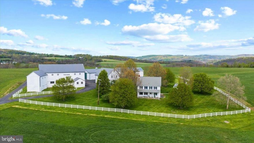 Set amid the rolling countryside of Upper Bucks County, this remarkable 156 acre historic farmstead offers a rare opportunity to steward a true piece of Pennsylvania history. Held within the same family since the 1700s, the property reflects generations of agricultural heritage and presents a landscape that has been thoughtfully worked, admired, and protected for centuries. The farm is anchored by a traditional farmhouse and a charming historic summer kitchen, complemented by a striking, old bank barn that features gorgeous stone work and serves as the centerpiece of the farm’s outbuildings. Two large pole barns and additional structures provide abundant space for equipment, storage, livestock, or continued agricultural use. Over the years, the land has supported various farming operations including crops, dairy production, and most recently hay cultivation, demonstrating the acreage's productivity and versatility. A significant portion of the land is protected under agricultural preservation, ensuring the integrity of the farmland and the sweeping rural landscape for generations to come. Included within the overall acreage are two tracts that lie outside the agricultural easement, offering additional flexibility. The first is a four-acre building envelope where the existing farmhouse and farm structures are situated. The second is an approximately 4.78-acre tract which may offer the potential for one or two additional building lots, subject to township approvals. Sweeping fields, open pastures, and wooded edges create truly unparalleled long-distance views across the Bucks County countryside. Properties of this scale are exceptionally rare, representing one of the largest tracts publicly offered in Bucks County in years. Own a piece of history in this once-in-a-lifetime offering - whether continuing its agricultural legacy, establishing a private country estate, or safeguarding a remarkable stretch of Bucks County landscape for generations to come. Peacefully rural yet conveniently located, the property is just 25 minutes to Doylestown, 35 minutes to New Hope, approximately 75 minutes to Philadelphia, and about 90 minutes to New York City. A property of this scale, beauty, and historical significance is seldom available - an enduring landscape where the past, present, and future of Bucks County meet.
