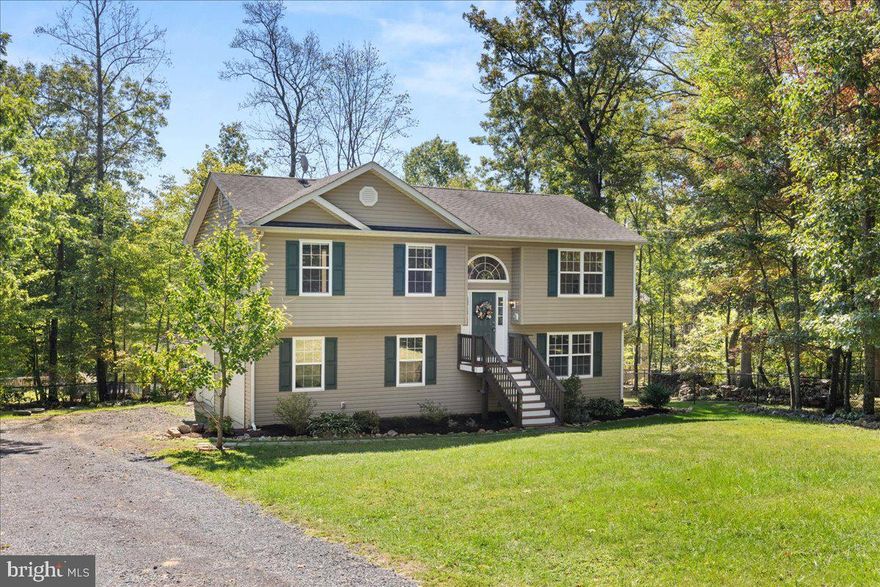 Welcome to this charming home offering 3 bedrooms, 2 full bathrooms, and over 1,300 sq. ft. of finished living space (sqft is estimated). Step inside to find a warm and inviting layout with hardwood floors and new carpet throughout. The bright living area features a cozy propane fireplace, perfect for relaxing evenings. The kitchen offers easy access to the spacious back deck with brand-new composite decking, ideal for outdoor entertaining or quiet mornings with nature. The lower level includes a partially finished basement, giving you flexible space for a family room, home office, or gym, plus plenty of storage options. Set in a peaceful community just outside of Winchester, this home blends comfort and convenience.