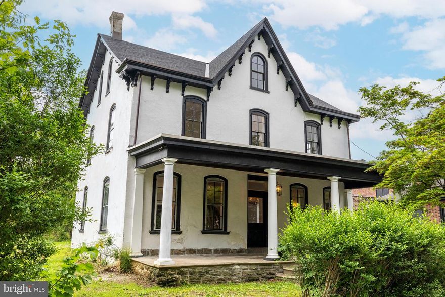 Step back in time—without sacrificing modern comfort—in this remarkable ca.1866-built home, steeped in local history and architectural character. The Gothic Revival and Italianate style house was built as part of the development of the Chew Estate, where the Battle of Germantown took place during the American Revolution. In fact, the house sits on one of the "Battleground Lots". The first owner was Catherine Price, who was a "Dunker," a moniker for adult baptism in the Church of the Brethren. The second owner was Samuel Harting, an important local builder, bought the house in the early 1900s, at which time he made his mark with a sweeping renovation that brought the house into the modern age of its time. He even constructed the striking brick building next door as his personal office—a decorative gem designed to showcase his craftsmanship.

Today, the home still stands as a testament to quality and care across centuries. Cross the wide front porch and enter through the original front door into a gracious formal foyer. To the right, a massive front parlor welcomes you with soaring ceilings and an original gilt mirror that’s seen generations pass through its reflection. Across the foyer, the dining room lies just ahead, accented with built-in cabinetry that feels both timeless and intentional. Antique oak floors run throughout the first and second floors, grounding the home with warmth and history.

In the rear of the home, you’ll find a smartly updated kitchen, a convenient powder room, and a laundry room with first-floor access—offering 21st-century ease within a 19th-century shell. Upstairs, the second floor features four bedrooms and two full bathrooms. One bath retains its antique soul, boasting original tile work and mirrors, while the other—a sprawling, luxurious space—anchors the primary suite. The third floor offers two more spacious bedrooms and a massive storage closet, easily adaptable to your needs.

The home has been thoughtfully maintained, with major updates where they count, including a new main roof in 2021 and central air throughout.

This is not just a home—it’s a piece of Germantown’s living history, lovingly updated and ready for its next steward. Please note listing agent has a financial interest in this property.