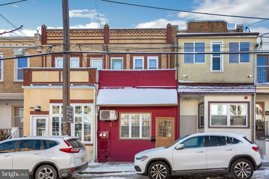 Wonderfully flexible property in Narberth! Currently used as a large studio/workspace with loft in the front and a completely separate apartment in the rear, accessed through its own private entrance. The studio space has a sink on the main floor and then down a few steps which lead to the basement, there is a full bath. There is also more basement storage space down a few more steps. The loft has a half wall, so is open to the high-ceiling studio and is a great place for an office or more private area than the open space below. The studio could be used in many different ways, including as an artist’s work space or a more traditional office space. Furthermore, by opening up a doorway that was originally open between the studio and the apartments’ living room, the entire building could be returned to a single living space. Because the studio is currently one large space, the possibilities are limited only by the buyers’ creativity.
The apartment is located down a private path around the corner. There is a little garden out front and a small patio. The updated kitchen provides plenty of counter and storage space and the high ceilings and many windows make it bright and airy. There is a nook for dining and a living room space next to the stairs. The second floor features a large primary bedroom with ample closet space and a door to the private balcony overlooking Woodbine Ave. The second bedroom can accommodate a twin bed and the bathroom has been updated. The small third room is perfect for a nursery or office and provides access to the roof deck which is a great place to relax in a serene setting.