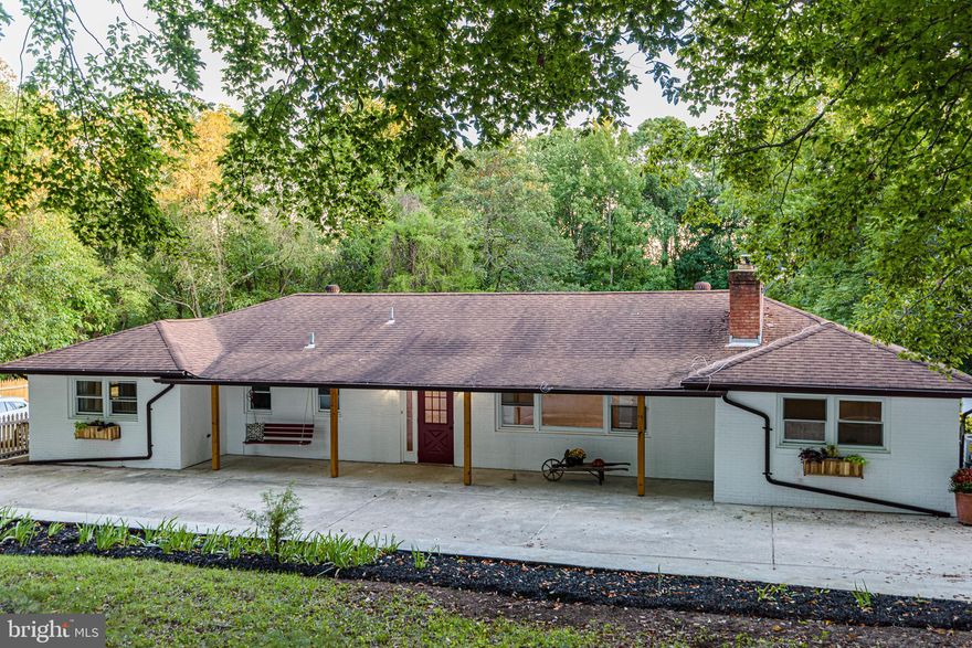 Welcome home to this 5 bedroom 31/2 bath (3872 square foot) fully renovated rancher with 1+ car detached garage fully finished walk out lower level on a private .87 acre lot overlooking mature shrubs and trees.
  Entering the foyer, stone floors and a large closet with barn door open up to the freshly painted neutral living room. Refinished, richly stained hardwoods, large fireplace with antiqued wood mantle, custom huge window and recessed lighting make this room feel special. The open floor plan moves seamlessly into the dining room which also has a view of the fireplace for cold evenings or to create additional ambience when entertaining.  A custom wooden wall treatment sets this dining room apart, and french doors leading out to the deck make al fresco dining a breeze. The dining room is open to the custom kitchen. Dark blue kitchen cabinetry, with gold handles and crisp white quartz counter-tops look classic and stylish with the double white herringbone patterned back-splash that goes all the way up to the ceiling.  Stainless-steel appliances and quartz breakfast bar and high-end lighting fixtures  finish off the design in both of these rooms.   Hardwoods and plenty of light make this a great place to play a game with the family or snuggle up and watch a movie. There are four bedrooms and two baths on this level. All of the bedrooms are spacious and have good light and hardwood floors. The hall bath is modern and fresh. The tile design in this room incorporates beautiful large floor tiles and white subway tile in the tub/shower that is enclosed by glass.  There is also a custom floating vanity with plenty of storage, a contemporary lighting fixture, recessed lights and a round mirror to complete the look. The primary suite catches your attention immediately. As you enter, directly across from the bedroom door, there are shaded, high end wall sconces,  on each side of a large window. In the center of the room there is another shaded hanging light fixture that together with the scones, create a feeling of calm. This room also has hardwood floors. The en-suite bath is accessed through another barn door in the primary suite. The large walk-in shower with frameless glass has over sized tile throughout and custom subtle blue/gray floor tile that pull the entire room together.
Coming downstairs to the walk out lower level, there is a half bath just to the left, with new sink and toilet. Next to the half bath, is a large recreation room, with a space that is perfect for a large screen TV.  So, you can be the host for friends to watch the next big game. The game room, just beyond the recreation room, has a 7-foot granite wet-bar with gray cabinetry and small refrigerator, perfect for snacks and drinks. This level also has a contemporary updated full bath with custom tile and floating vanity and large 5th bedroom. This would allow guests their own private space or your teenagers dream bedroom/ bathroom situation.  There is also another large room that could be an office, 6th bedroom, exercise room or playroom. The large laundry is also on this level. We are currently investigating a potential septic issue which will either be fixed or a new system installed based on the findings before closing.