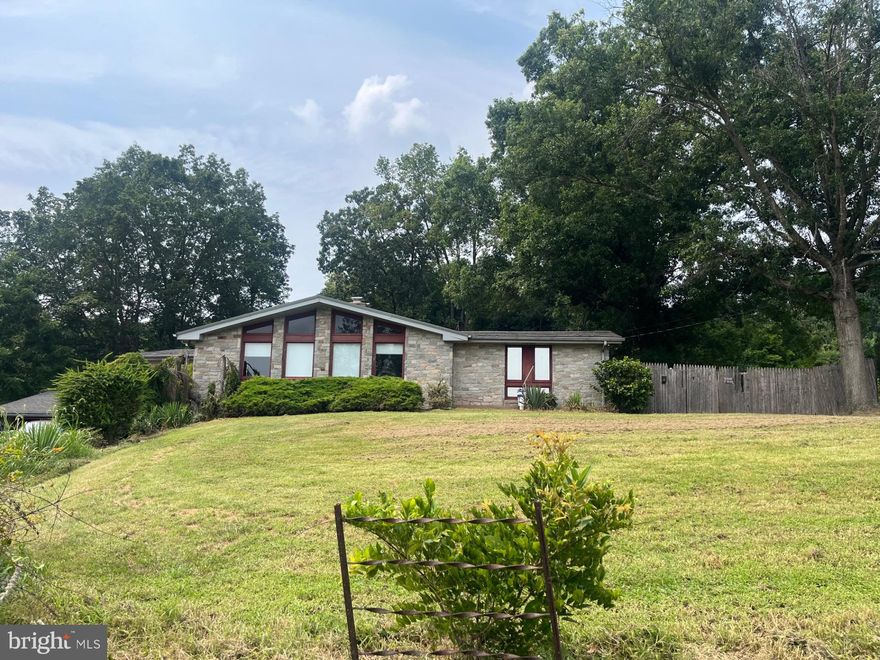 Welcome home to this charming, Frank Lloyd Wright inspired, property, situated on just over 5 acres, in a country setting but yet close enough for city access. You will find 4 bedrooms with a full bath on your main level living space, accompanied by a floor to ceiling stone fireplace and open floor plan. This two-story home offers large windows which allows for plenty of sunlight, a fully finished lower level to make into a separate living space, in-laws quarters or your very own lounge.  You will have opportunity to make this home your very own, with your own upgrades, if you are looking for a project, this is your home! Enjoy your fenced in backyard, mature landscaping and orchard with apple and pear trees. This property has it all, plus additional two car detached garage and many acres to enjoy wildlife! Make sure you schedule your showing today!