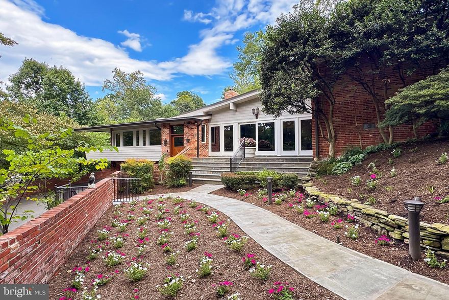 Get Ready, because I promise you have yet to see an Arlington Estate like this! Secluded and hidden by mature trees, stone paths and professionally manicured gardens, 1753 Army Navy Drive is like living year-round on vacation, while being minutes to EVERYTHING a metropolitan city has to offer. This 1+ Acre property offers a primary residence, full resort-style heated outdoor swimming pool, and a gracious guest house, so nice in fact that your guests may never leave.  The main residence is constructed of solid brick and features numerous high-quality interior features including sound proof Anderson windows, Hunter Douglas blinds and numerous custom built-ins.  Inside you will find an exposed brick entryway, Brazilian Cherry floors, 10+ foot ceilings, surround sound, elegant moldings, 2 mantled gas fireplaces, recessed lighting, and exposed beam ceiling. While this home is grand in every way, it is never ostentatious. Instead, it is warm and inviting with the perfect combination of formal and informal spaces, and multiple outdoor patios. The kitchen is a chef's dream  offering a Wolfe 6 burner gas range with griddle and double oven, stainless steel wall oven plus convection microwave, a Sub-Zero refrigerator freezer, butler's pantry with wine fridge and the most impressive of center islands with pendant lights, and ample bar stool seating.  The home's upper levels offer 4 bedrooms, which include not one, but two spectacular primary suites, located on separate levels. The property features two home offices: one is private and well-suited to serve as a library or den, wiht it's built in bookshelves and limestone surround fireplace, while the other offers an open-concept design with versatile possibilities.  And just when you think the home could not be any more impressive, the breathtaking outdoor pool with waterfall feature, and gracious sun deck might just change your mind. The separate guest house is not just a pool house. This is truly another residence offering a full kitchen, two bedrooms, two full baths, separate laundry, and a dramatic family room with floor to ceiling windows and its own private patio. Not to be missed, this property includes a front load garage that can accommodate three cars, is temperature controlled, offers space for a workshop and includes a private powder room. The driveway can easily make room for 3 to 4 additional cars, and the home’s entrance offers a private parking pad for 2 additional vehicles. Schedule your private tour today and prepare yourself to be amazed! SPECIAL NOTE: The total number of bedrooms and baths listed are the main house (four bedrooms, four full baths and three  half baths) and the guest house (2 bedroooms, 2 full baths) combined. Adjacent parcel of land also included in sale.