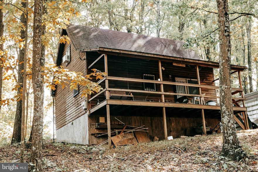 Your house hunting is over! Make this cozy, cabin your full-time residence or getaway! Beautiful fully furnished home on over 7 acres of wooded land. Enjoy the views from all parts of the property. 1 bedroom and 1 full bath on first floor. Large kitchen and living area for gatherings. Upstairs loft with bedroom and half bath. Pellet stove in the living room. Private well and private septic. Carport included to park under and enjoy the outdoors. Be sure to relax at the fire pit. Just in time for hunting season!