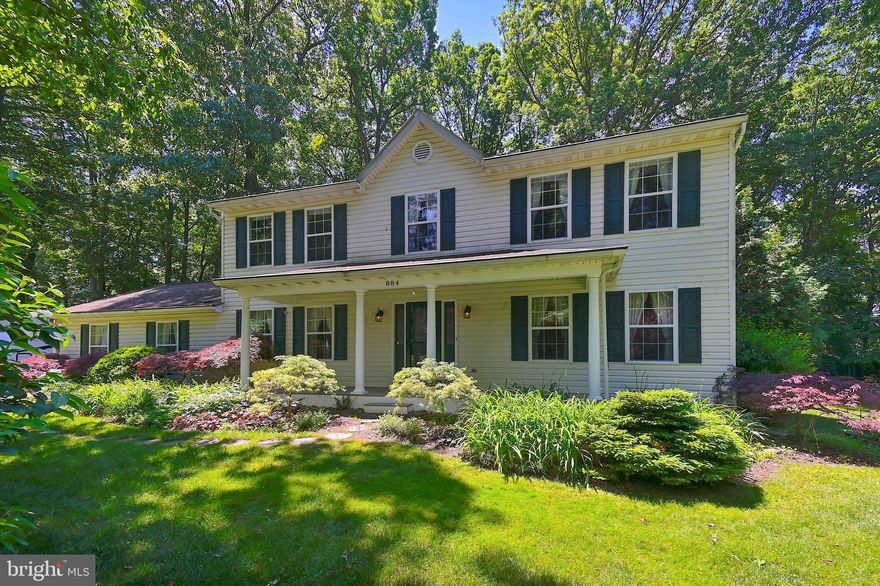 There is no place like HOME! Turn the key to this outstanding Colonial Home with a front porch on a gorgeous, landscaped lot!  This home is tucked away at the top of the driveway.  You can relax on the front porch or spend the day on the huge, composite deck with a retractable awning (awning is electric with manual back-up ; vinyl trim on the front porch and back deck)! This home offers 4 bedrooms, 2.5  baths with an attached 2 car garage. If you like to garden, YOU HAVE FOUND THE RIGHT PLACE!!!! The garden is landscaped with many perennials for you to adore! The interior of the home will delight you with generously sized rooms, a family room with a wood burning fireplace, ceiling fan and a view of the magnificent gardens! The kitchen features a pantry, lots of cabinet space, Zodiac Quartz countertops and all appliances. The separate dining room is perfect for gathering for celebrations and those special meals; chair rail in the dining room adds a nice touch! The upper level is where the 4 bedrooms and 2 full bathrooms are located, the rooms are generously sized; the Owners Suite has a ceiling fan, bathroom with double sinks and a walk in closet so you will have plenty of space for all your favorite outfits! Wood flooring is throughout most of the home, windows are vinyl clad, double pane with screens and tilt-in feature for easy cleaning; some windows have "blackout" blinds.  The HVAC is zoned to provide optimum comfort! Attached 2 car, side entry garage for your cars and/or storage.  Another bonus is that this home has been owned and lovingly cared for by the same owners since it was built, it also has whole house surge suppressor on the electrical panel.  Only short distance to town and shopping while still feeling private and tucked away!  Don't wait, act NOW to call 884 Woodleigh Drive "HOME"!